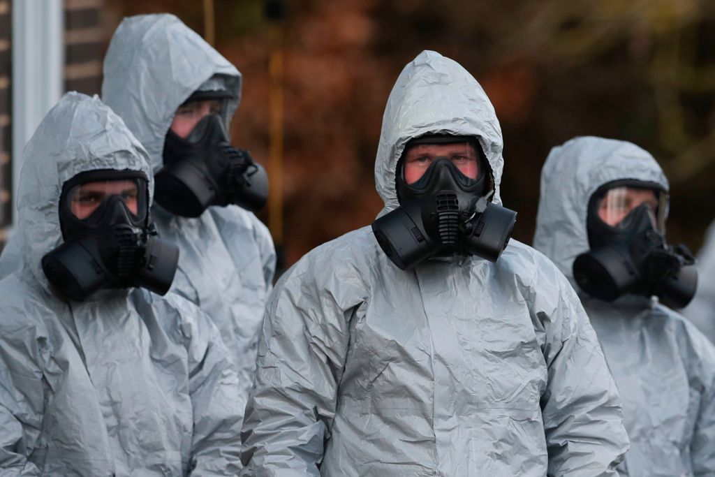 Personnel in protective coveralls and breathing equiptment work at the Salisbury District Hospital in Salisbury, southern England, on March 10, 2018, in connection with the major incident sparked after a man and a woman were apparently poisoned in a nerve agent attack.. (Photo credit should read DANIEL LEAL-OLIVAS/AFP/Getty Images)