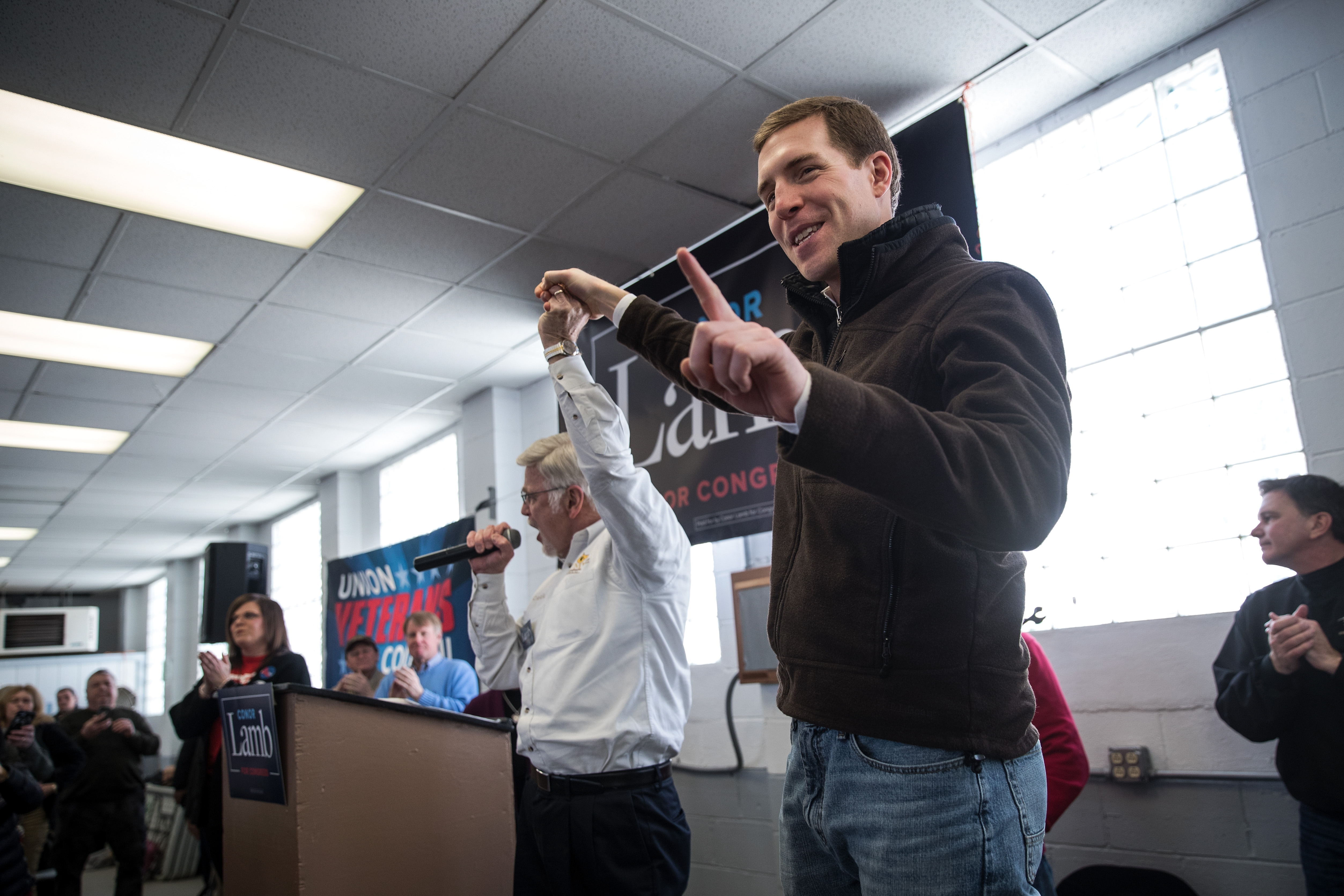 UMWA President Cecil Roberts (L) and Conor Lamb, Democratic Congressional candidate for Pennsylvania's 18th district, gesture at a campaign rally with United Mine Workers of America (UMWA). CREDIT: Photo by Drew Angerer/Getty Images