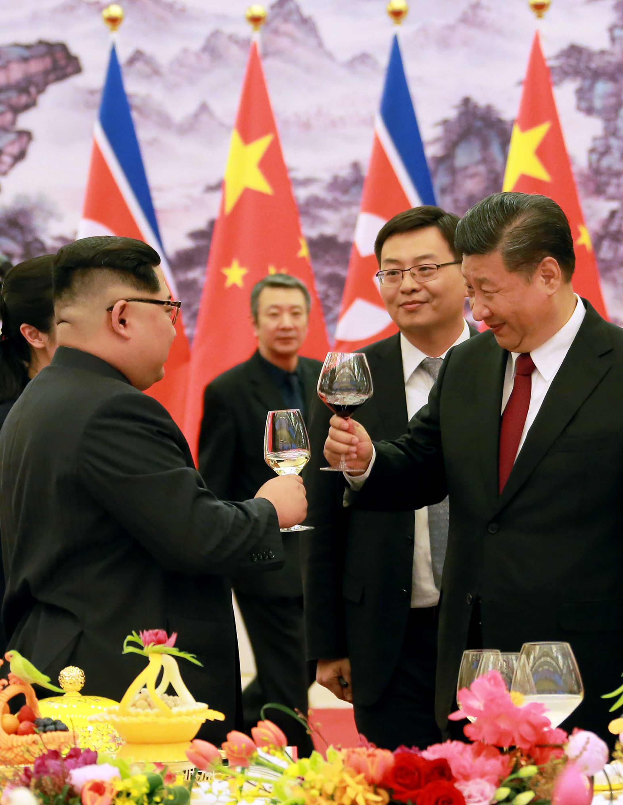 China's President Xi Jinping and North Korean leader Kim Jong Un toast raising their glasses at the Great Hall of the People in Beijing. CREDIT: AFP/Getty Images.