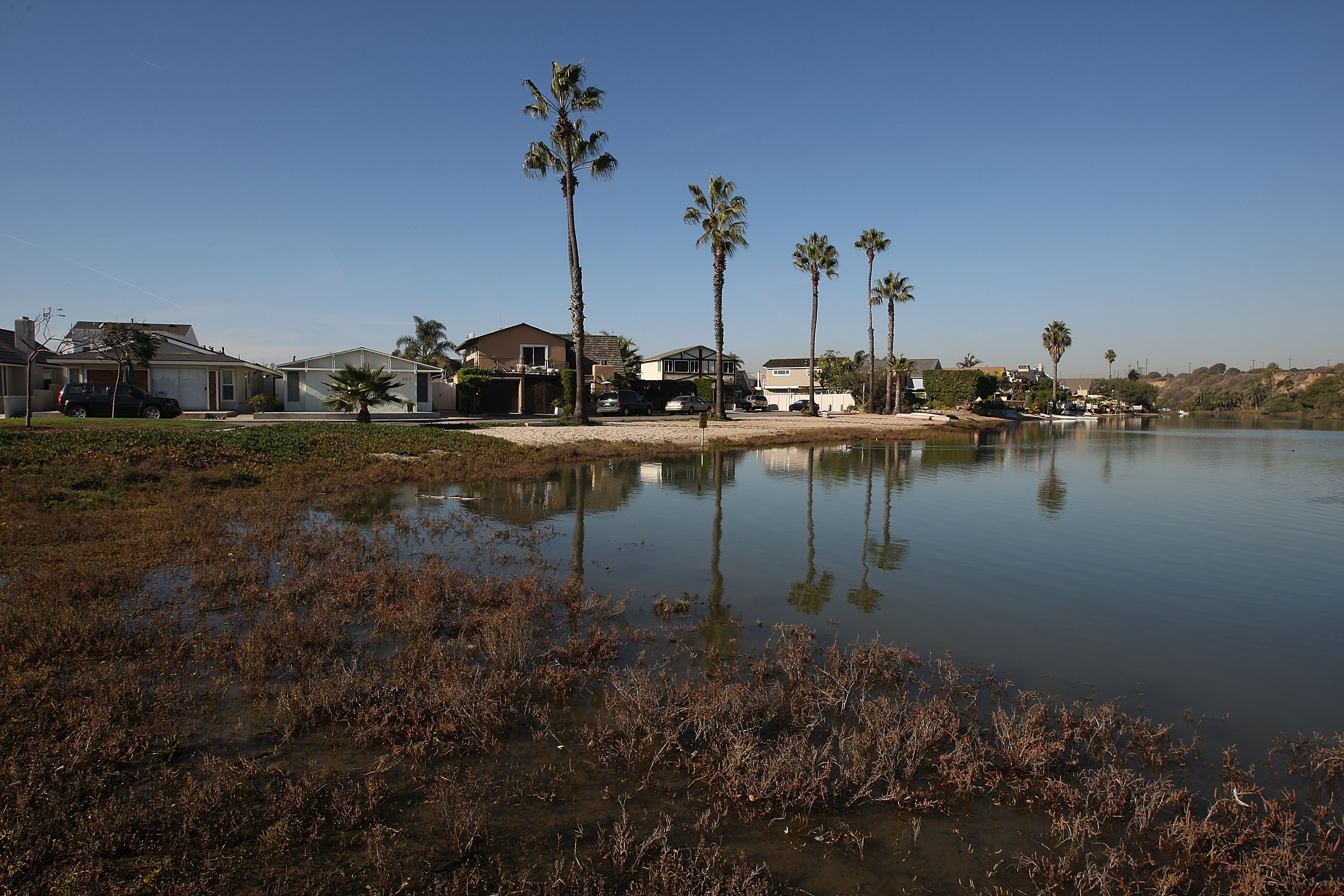 California homes in Newport Beach could be at risk due to sea level rise. A handful of California cities are suing fossil fuel companies for damages associated with sea level rise. (CREDIT: David McNew/Getty Images)