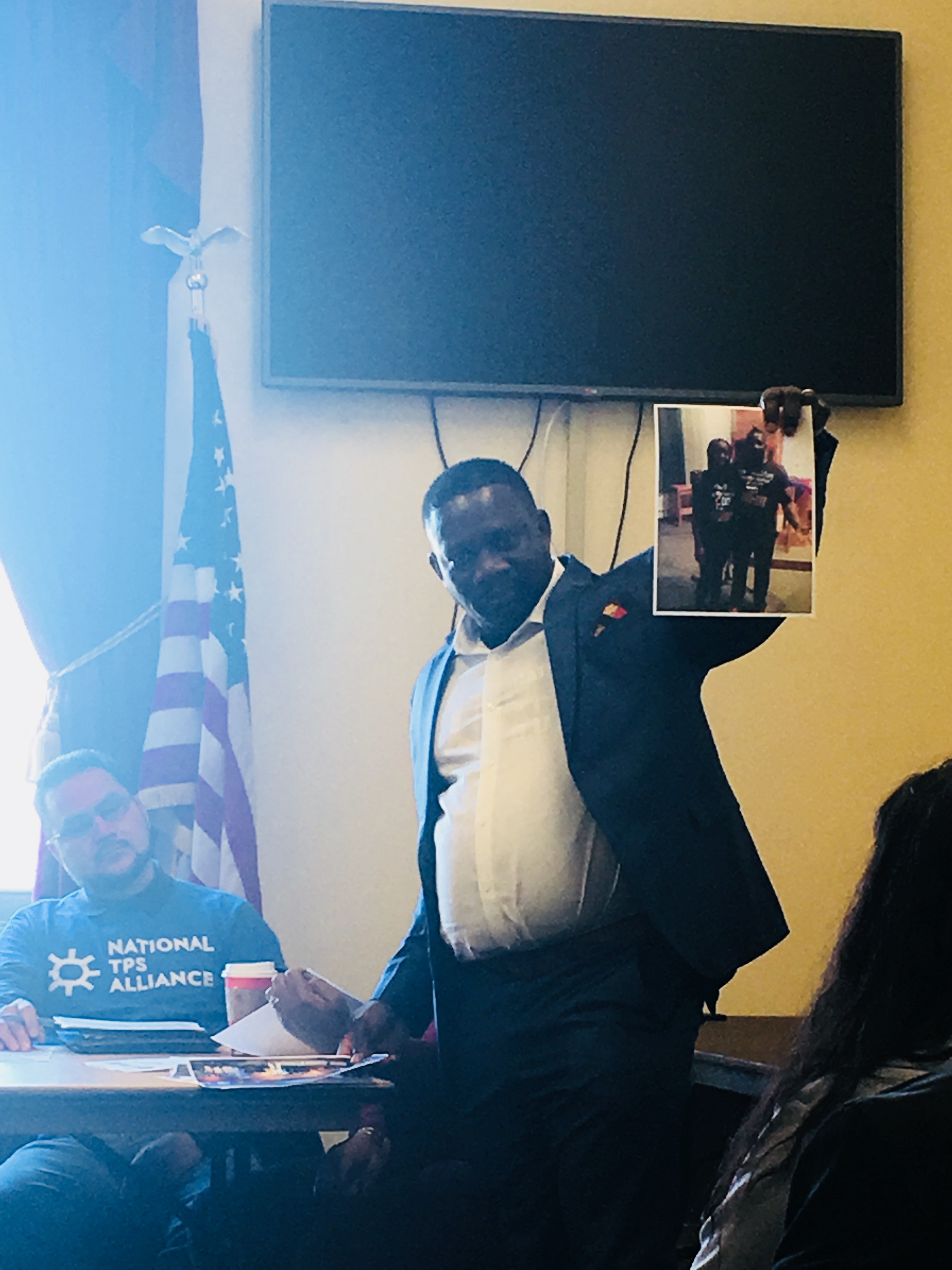 Pastor Moses Punni, a Deferred Enforced Departure recipient, holds up a photo of his 15-year-old daughter who he'd leave behind if he was deported if the program expires on March 31, 2018. (credit: Esther Y. Lee)