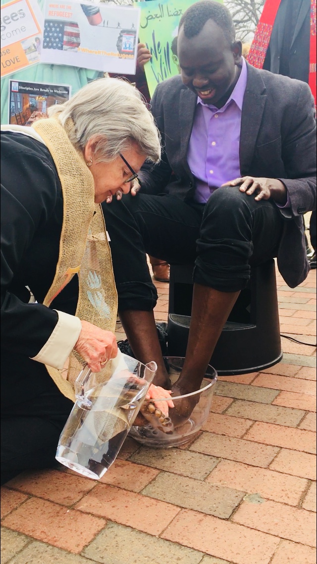 Sr. Marie Lucey washes the feet of Manyang Reath Kher, who who lived in refugee camps along the Sudanese and Ethiopian border and now has his own coffee business in Richmond, Virginia. (Photo: Esther Y. Lee)