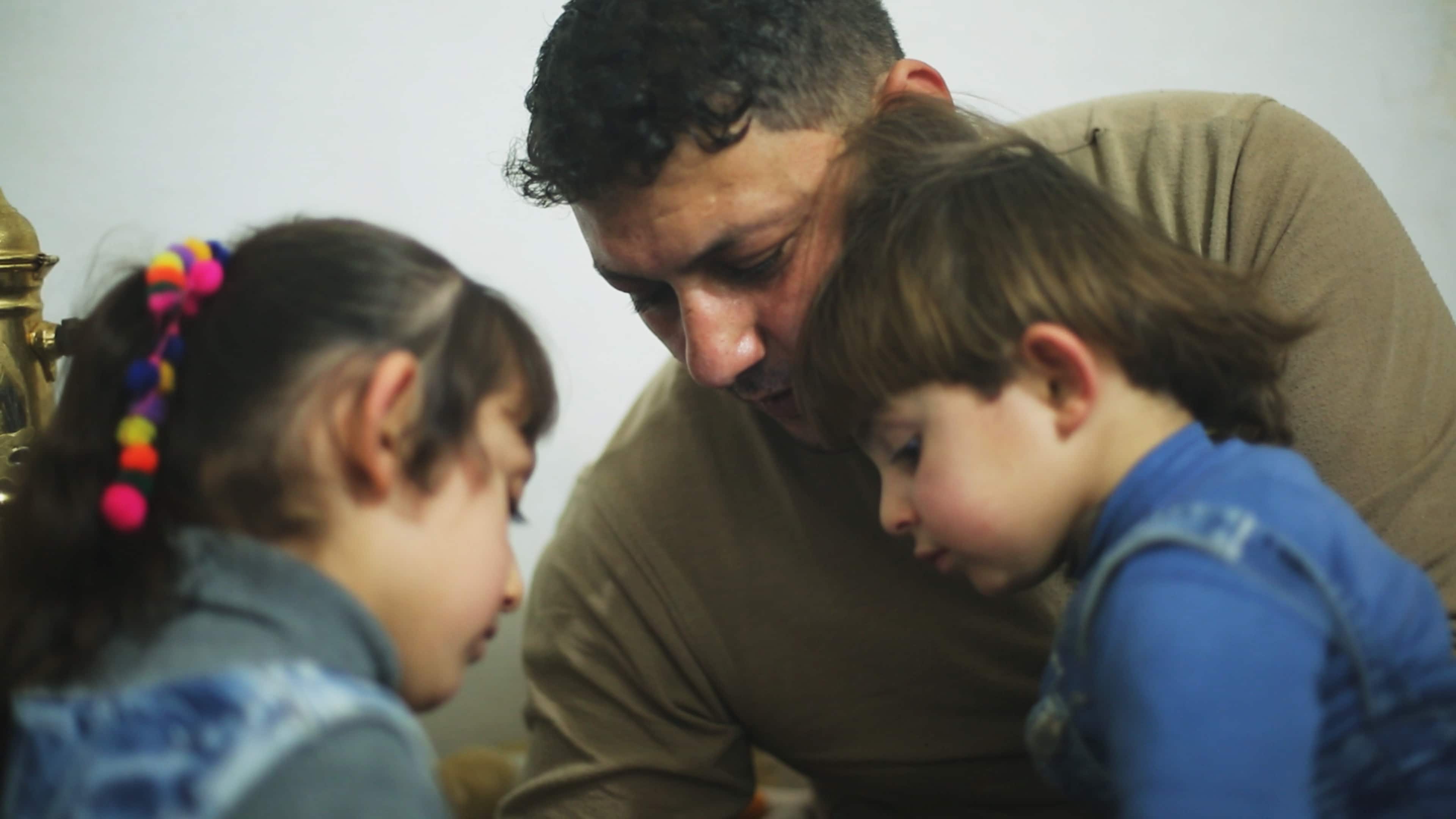 Khaled Omar Harrah with his daughters in "Last Men in Aleppo." CREDIT: Courtesy of Grasshopper Film.