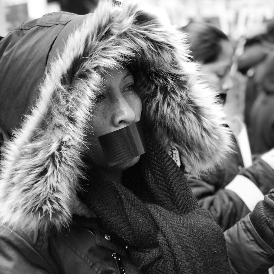 Silvia Perez stands in protest against abusive conditions in farms. (credit: Coalition of Immokalee Workers)