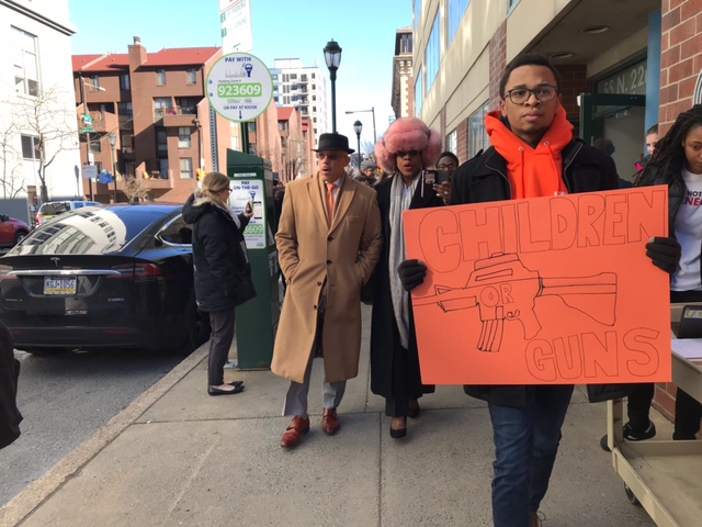 Tamir Harper holds a sign during the walkout on March 14. (CREDIT: Courtesy of Tamir Harper)