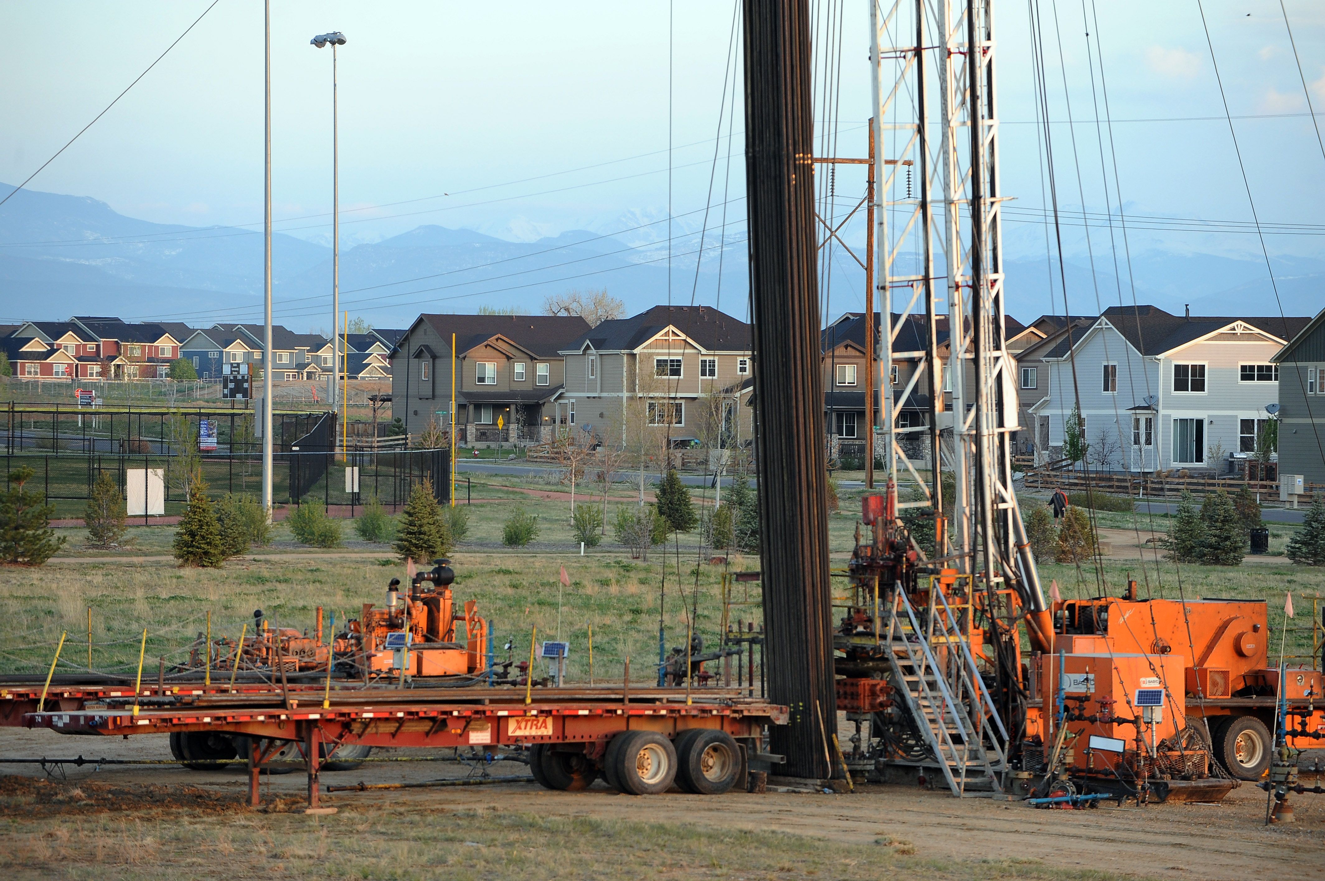 An oil derrick rises up in a neighborhood in Weld County, Colorado. CREDIT: Steve Nehf/The Denver Post via Getty Images