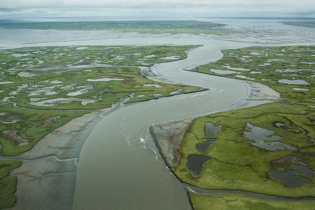 Newtok was established along the shores of the Ninglick River, near where the river meets the Bering Sea. The Yupik people have lived on the coastal lands along the Bering Sea for thousands of years. However, as temperatures rise the village is being threatened by climate change. (Credit: Andrew Burton/Getty Images)