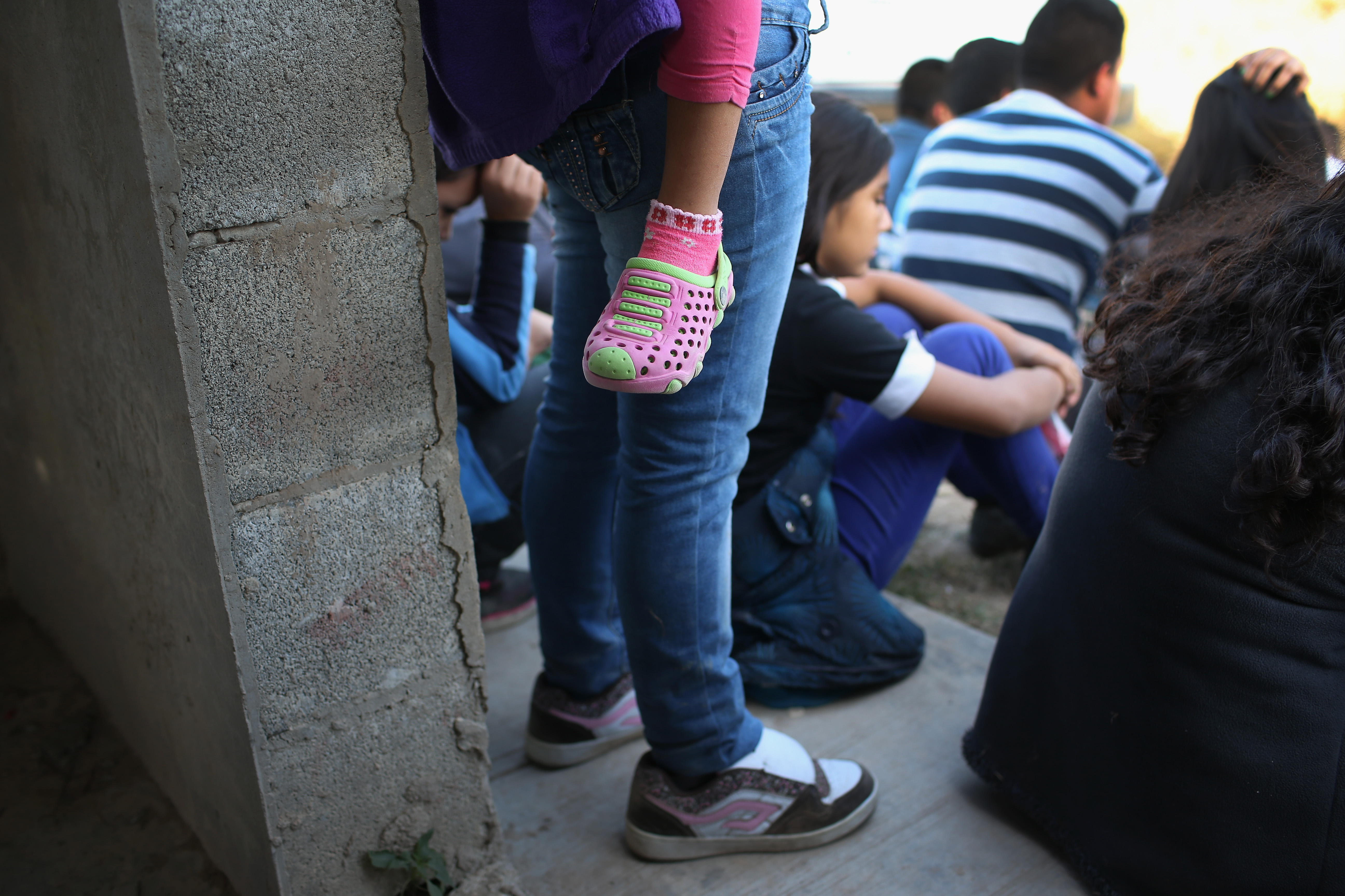 Central American immigrants wait to be processed after turning themselves in to U.S. Border Patrol agents on December 8, 2015 near Rio Grande City, Texas.(CREDIT: John Moore/Getty Images)