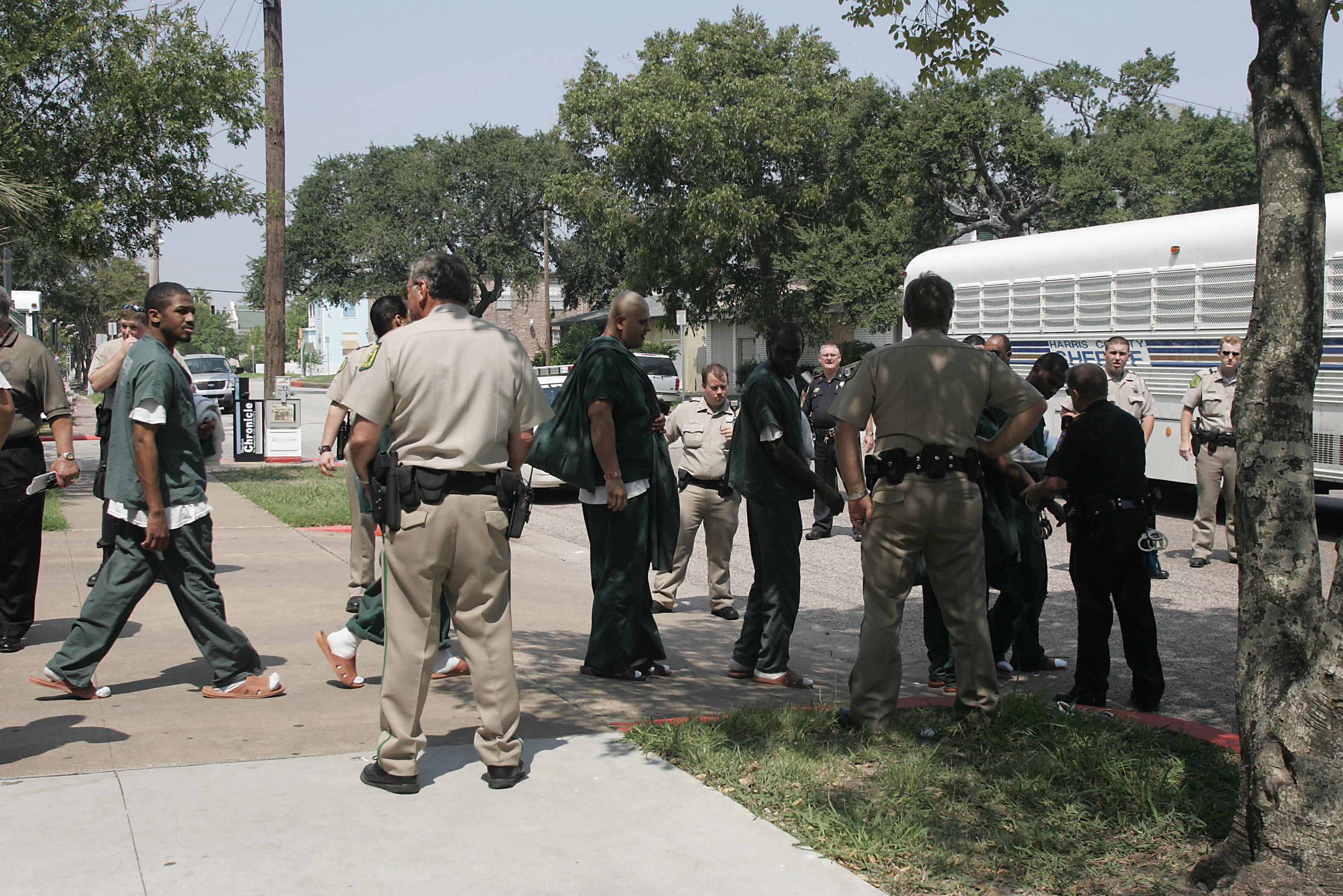 Galveston County Sheriff Department Deputy's along with Harris County Sheriff Deputys evacuate the Galveston County jail with buses and vans from the Harris County Sheriff's Department before Hurricane Rita in Galveston, Texas, September 2005. (CREDIT: JAMES NIELSEN/AFP/Getty Images)