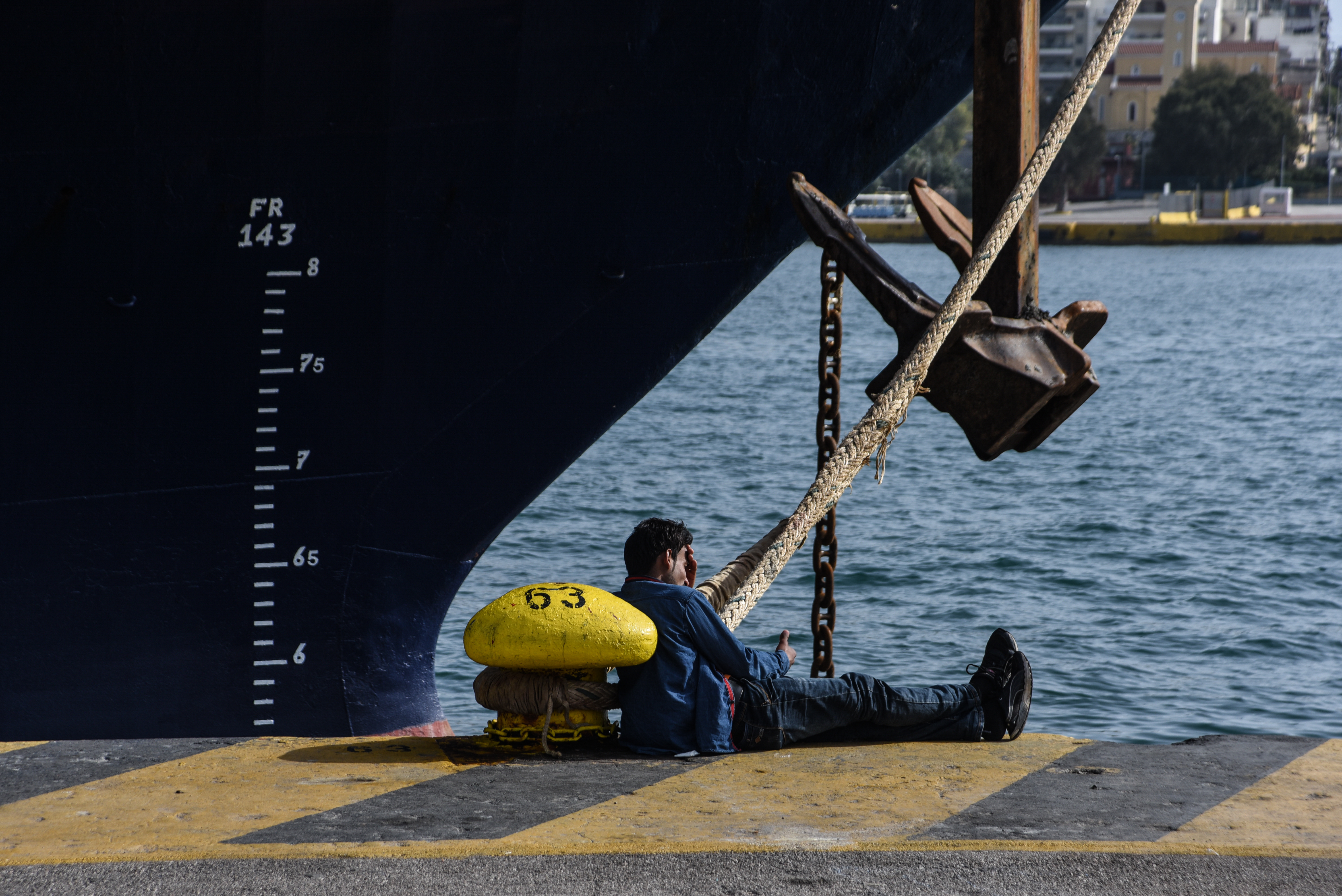 A refugee at the anchor of a ship in the port of Piraeus. (CREDIT: Wassilios Aswestopoulos/NurPhoto/via Getty Images)