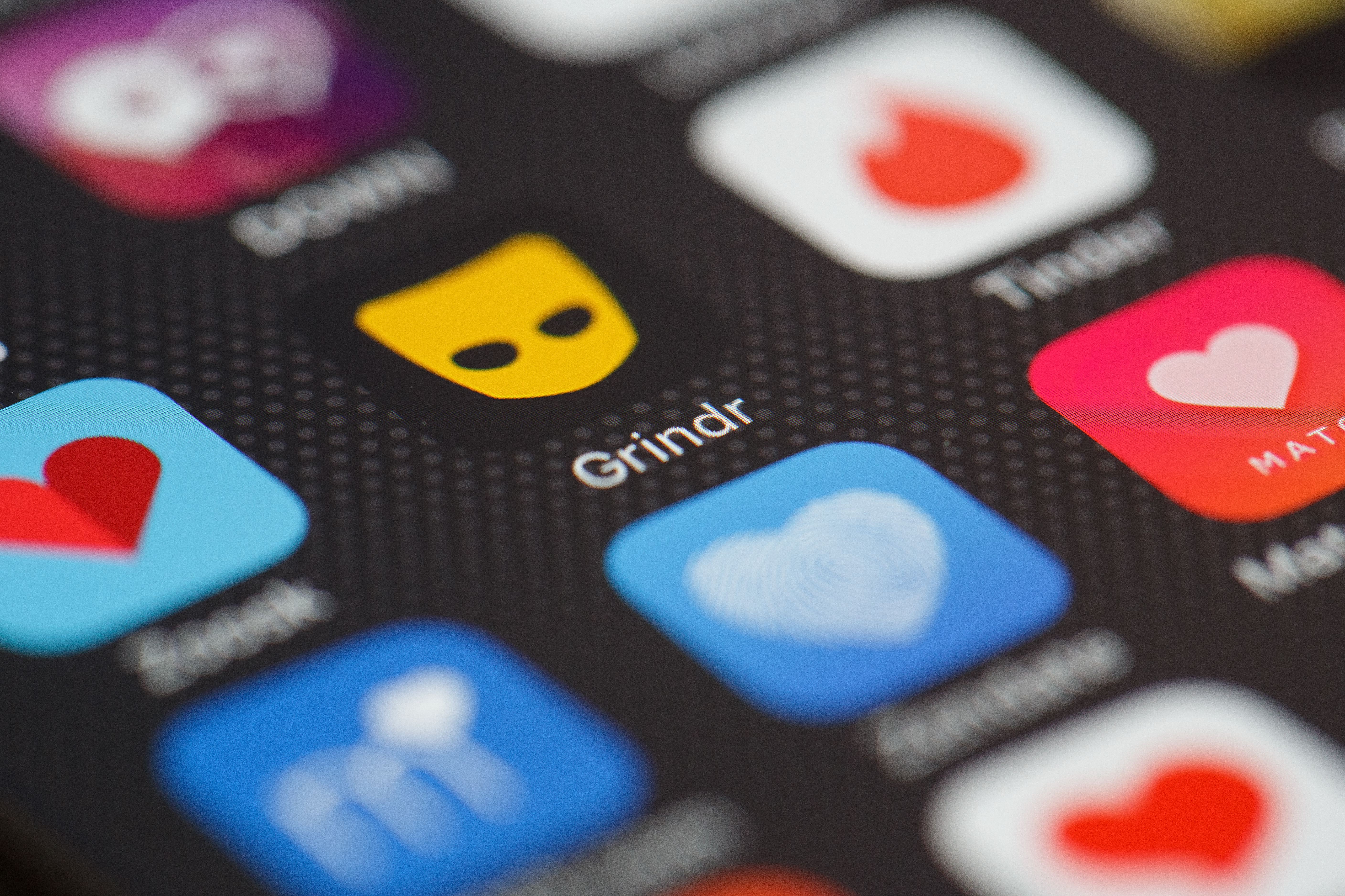 The "Grindr" app logo is seen amongst other dating apps on a mobile phone screen. (CREDIT: Leon Neal/Getty Images)