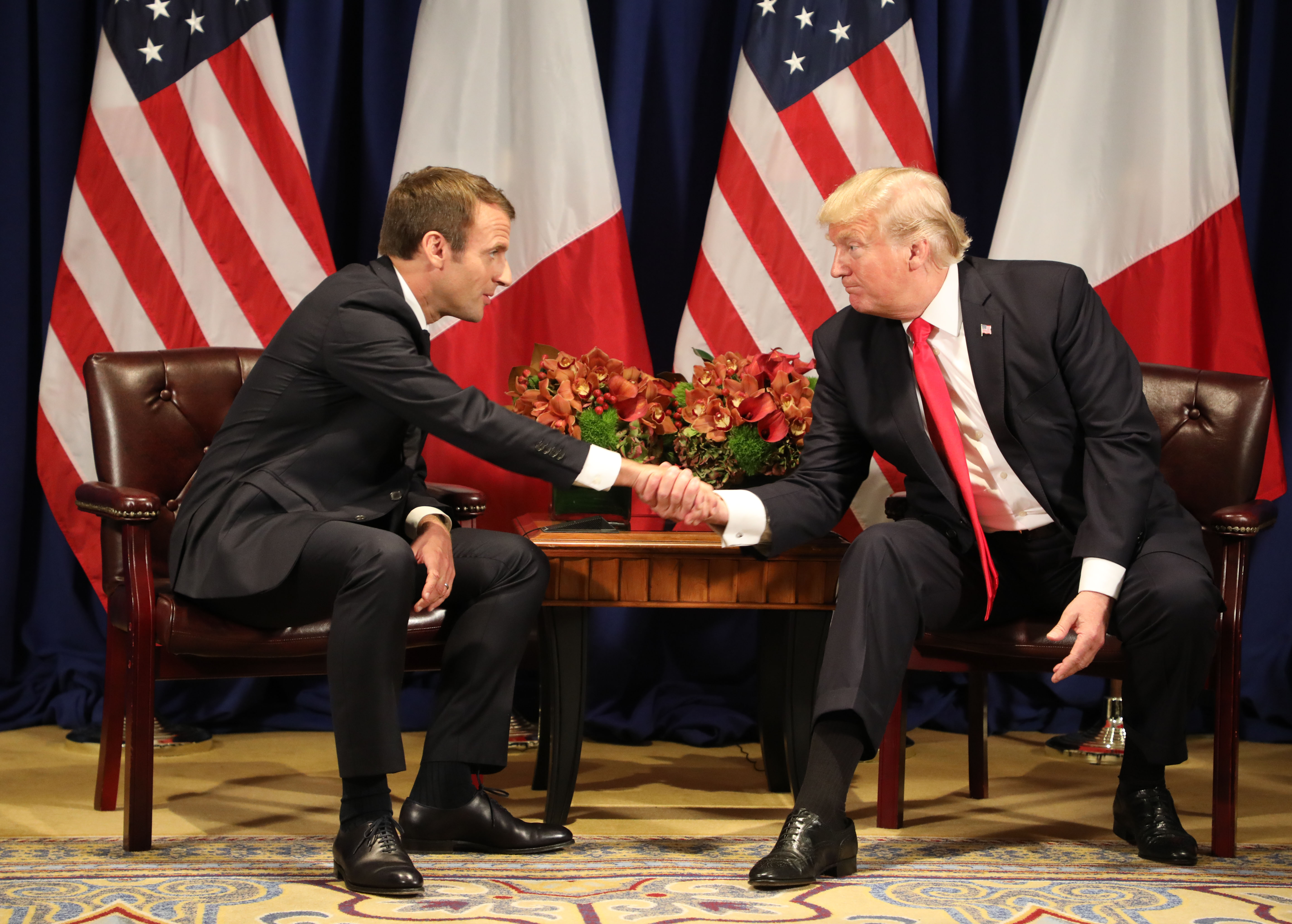 France's president Emmanuel Macron and President Trump shake hands before a meeting at the Palace Hotel during the 72nd session of the United Nations General Assembly on September 18, 2017, in New York. CREDIT: Ludovic Marin/AFP/Getty Images,