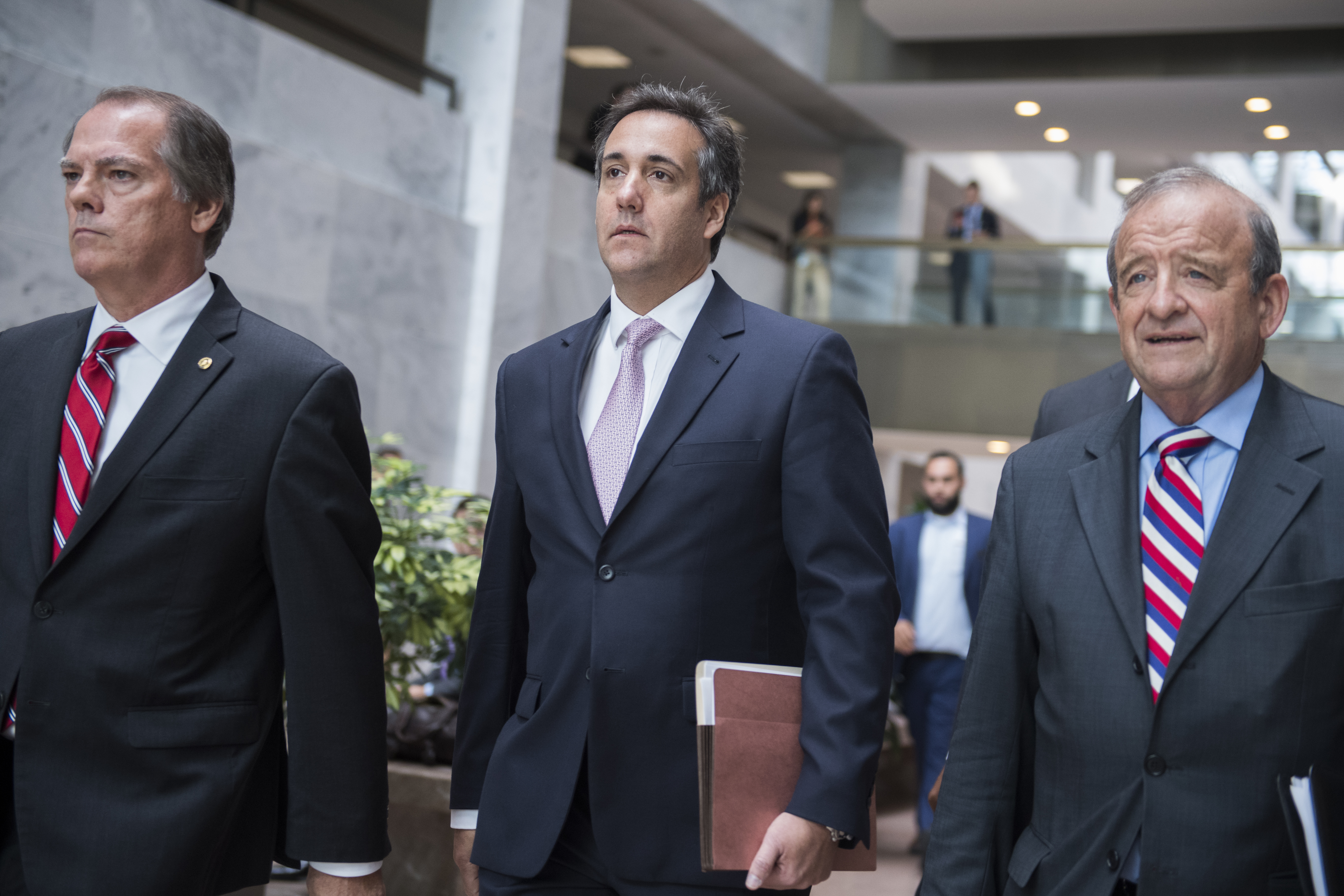 Michael Cohen, center, a personal attorney for President Trump, leaves Hart Building. CREDIT: Tom Williams/CQ Roll Call