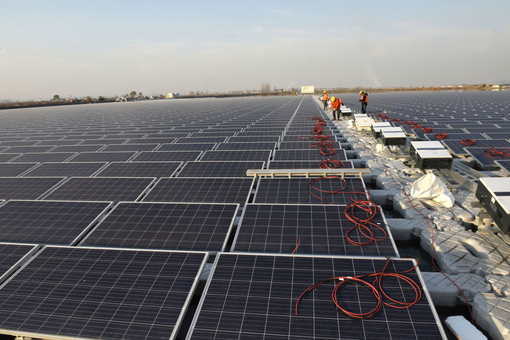 A solar photovoltaic plant being built above a pond in China, December 11, 2017.
Credit: Visual China Group via Getty Images.