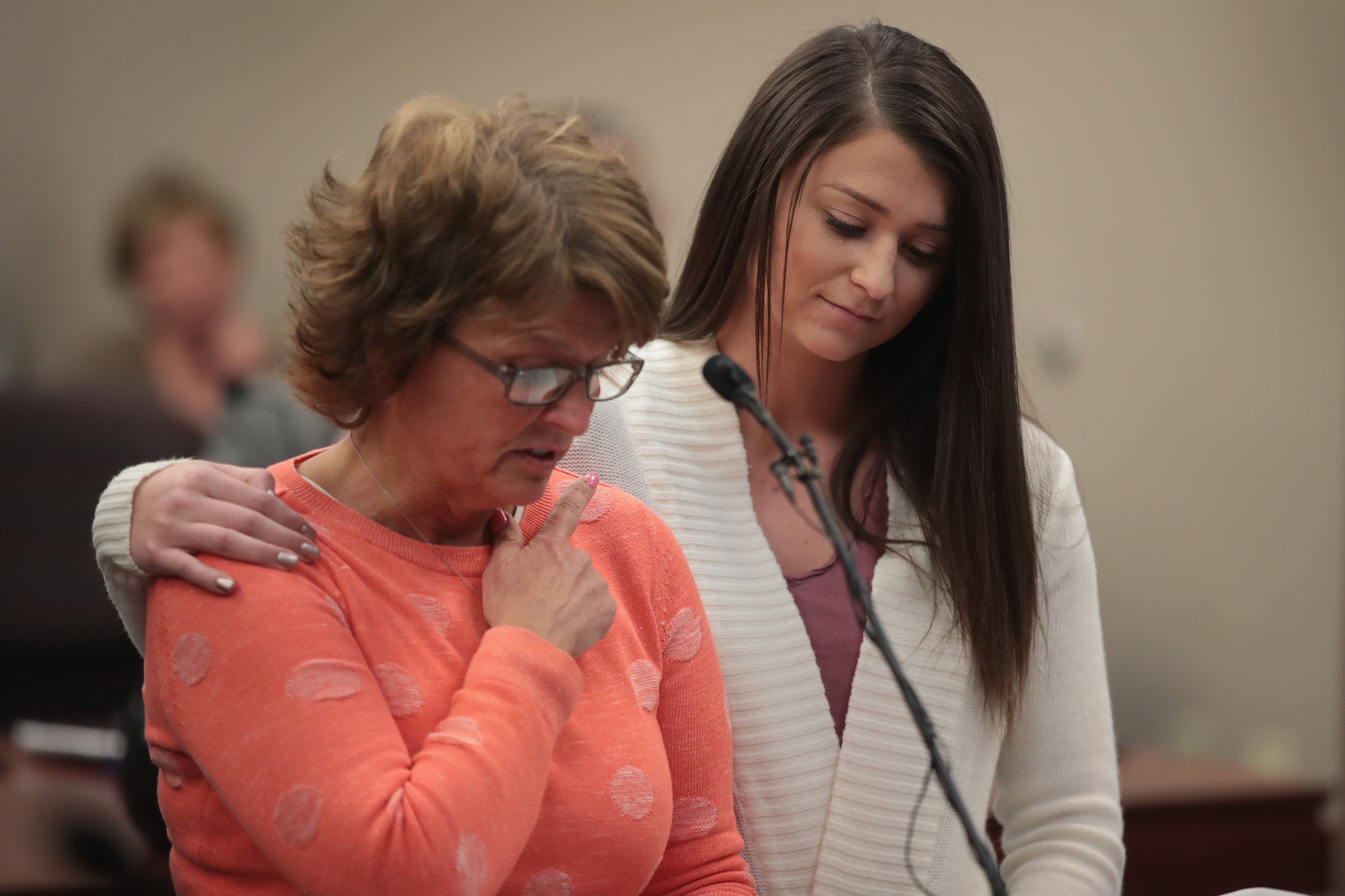 LANSING, MI - JANUARY 16: Lindsey Lemke (R) comforts her mother Christy as she reads a victims impact statement on her daughter's behalf at the sentencing hearing of Larry Nassar (Photo by Scott Olson/Getty Images)