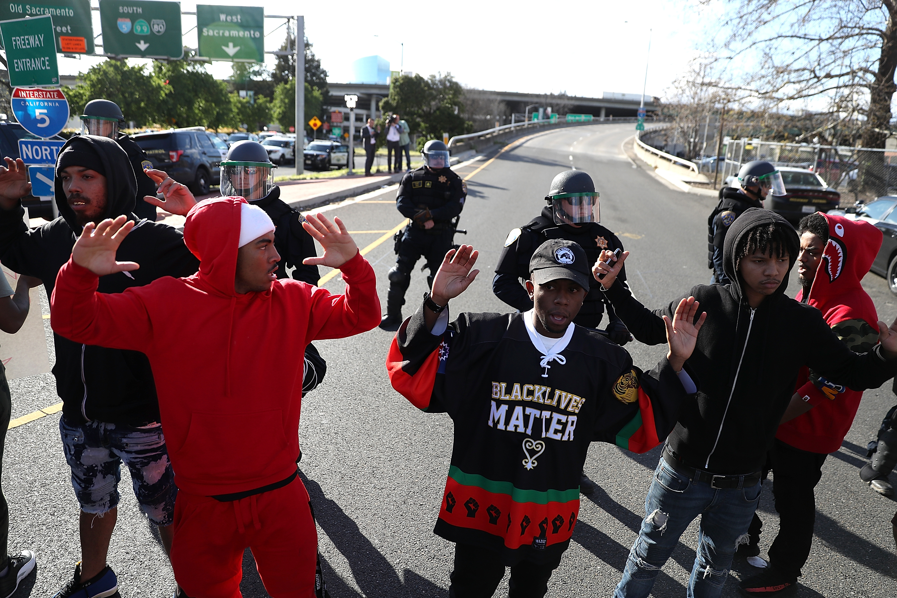 Protesters and California Highway Patrol officers on Interstate 5 during a demonstration against the Sacramento police department after two officers shot and killed Stephon Clark, an unarmed black man, in the backyard of his grandmother's house. CREDIT: Justin Sullivan/Getty Images