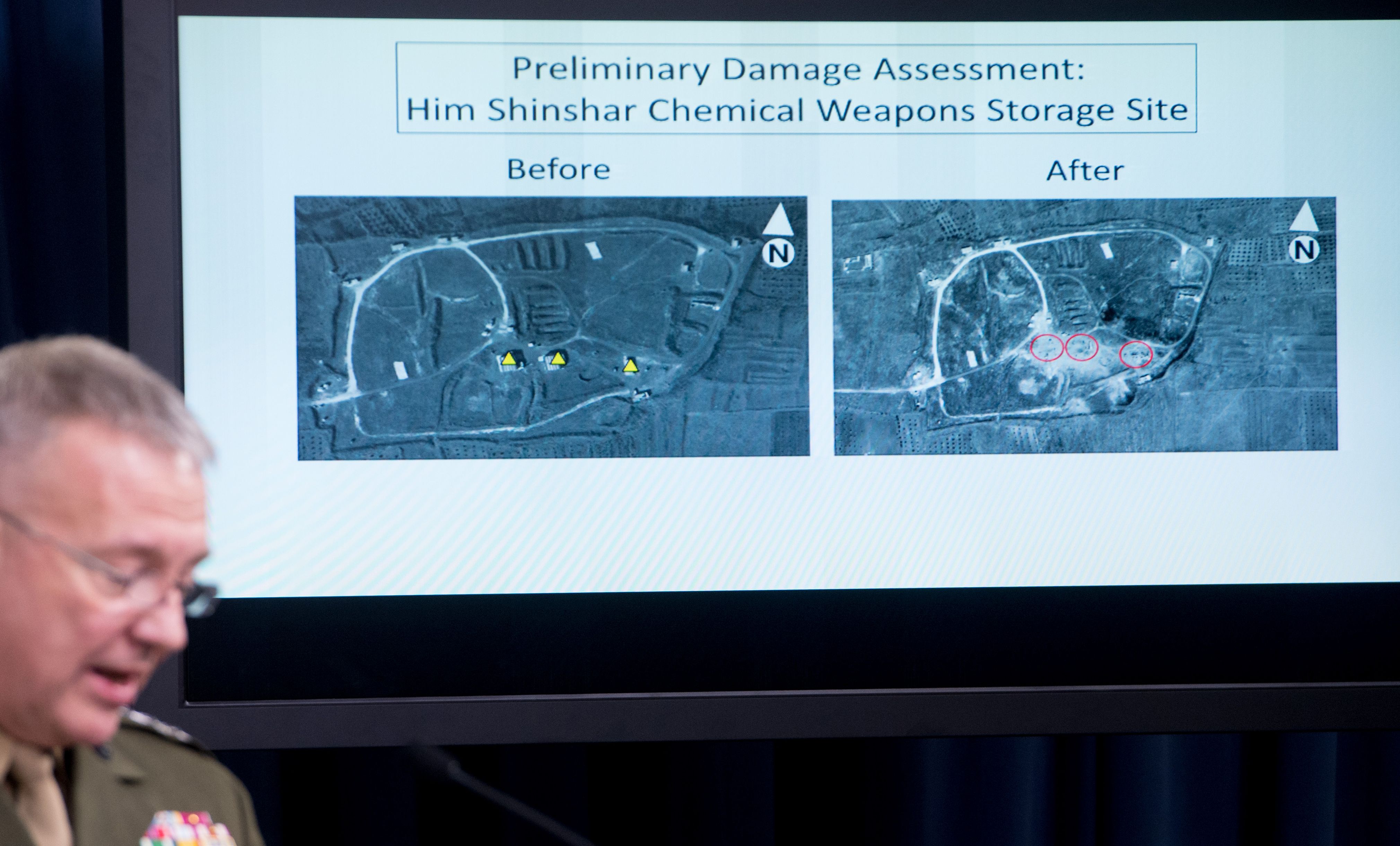 Director, Joint Staff, US Marine Lt. Gen. Kenneth F. McKenzie Jr., shows a damage assessment image of the Him Shinshar Chemical Weapons Storage site as he briefs the press on the strikes against Syria, at the Pentagon in Washington, DC, on April 14. 2018.
(CREDIT: Saul Loeb/AFP/Getty Images)