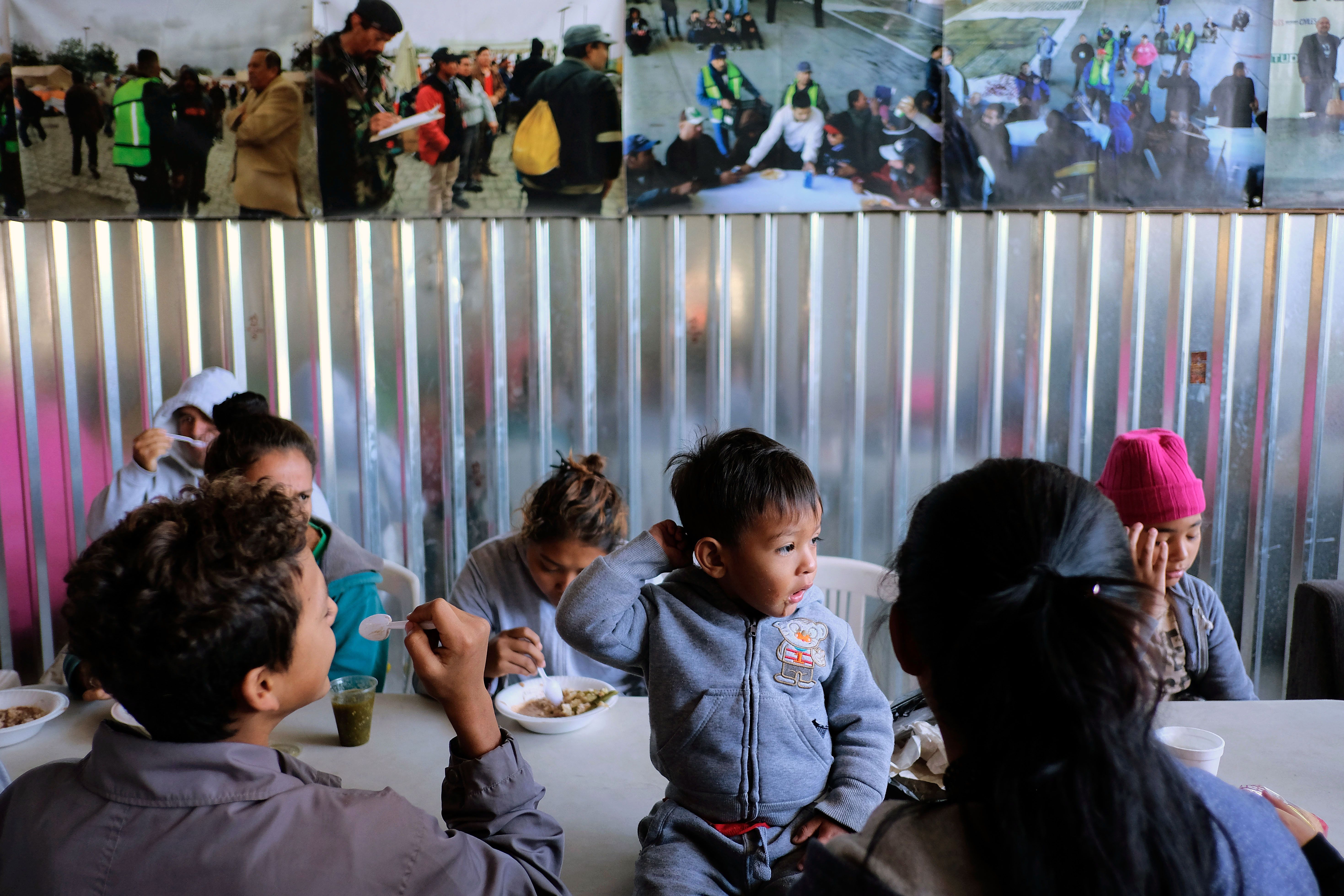 Central American migrants during the "Migrant Via Crucis" caravan, as they have breakfast at Juventud 2000 shelter in Tijuana, Mexico on April 17, 2018. (CREDIT: Guillermo Arias/AFP/Getty Images)