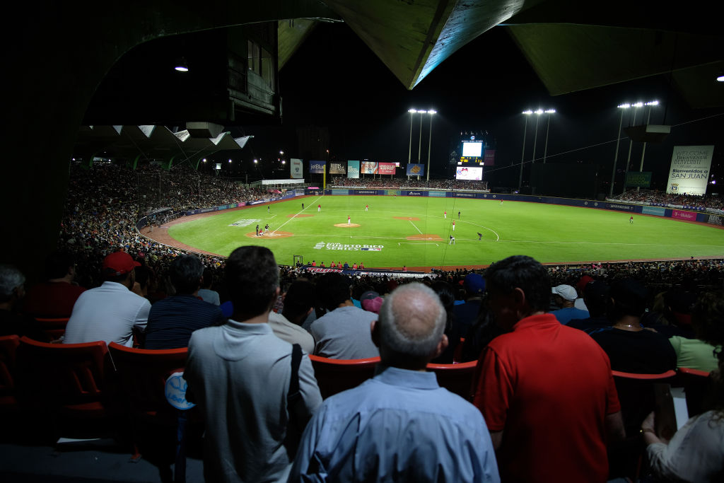 Fans watch the Cleveland Indians play the Minnesota Twins at the Hiram Bithorn Stadium. CREDIT: Ricardo Arduengo/Getty Images