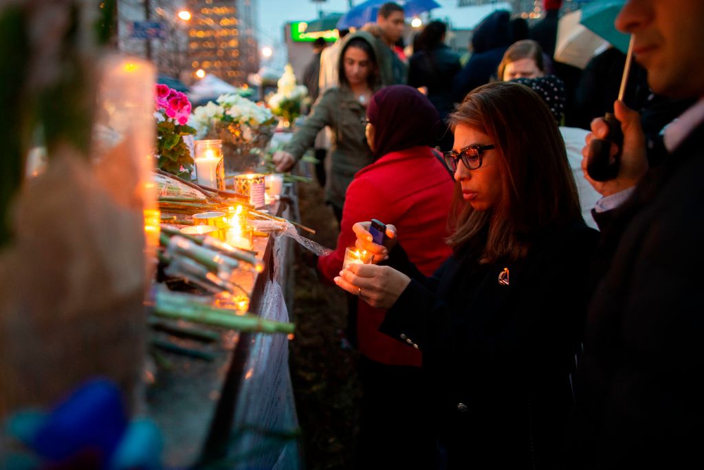 A woman lights a candle during a vigil near the site of the deadly van attack, April 24, 2018 in Toronto, Ontario. - A van driver who ran over 10 people when he plowed onto a busy Toronto sidewalk was charged with murder Tuesday. (Photo by GEOFF ROBINS / AFP) (Photo credit should read GEOFF ROBINS/AFP/Getty Images)