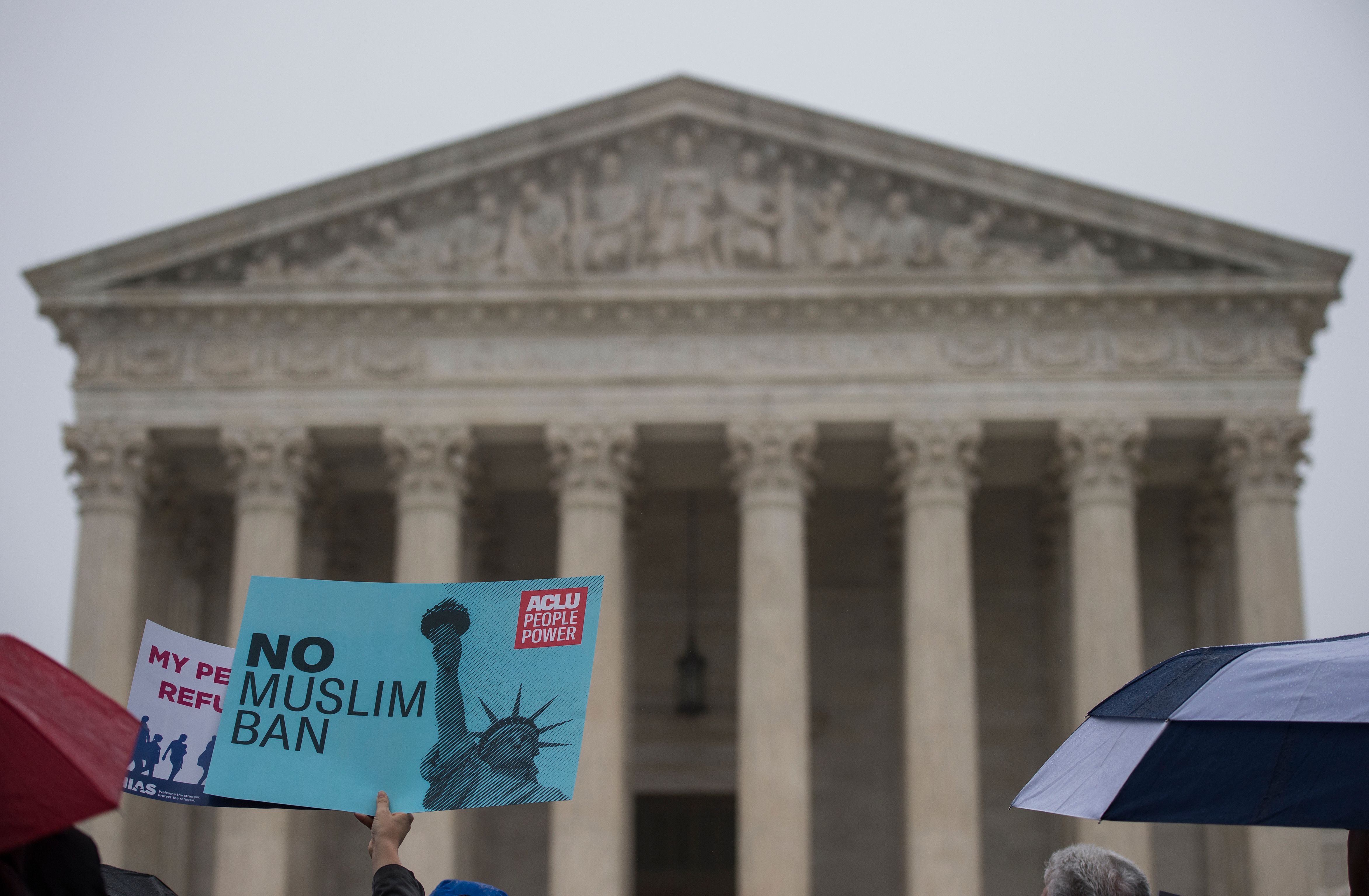 Activists rally against the Muslim Ban on the day the Supreme Court hears arguments in Hawaii v. Trump in front of the court in Washington, DC on April 25, 2018. (CREDIT: ANDREW CABALLERO-REYNOLDS/AFP/Getty Images)