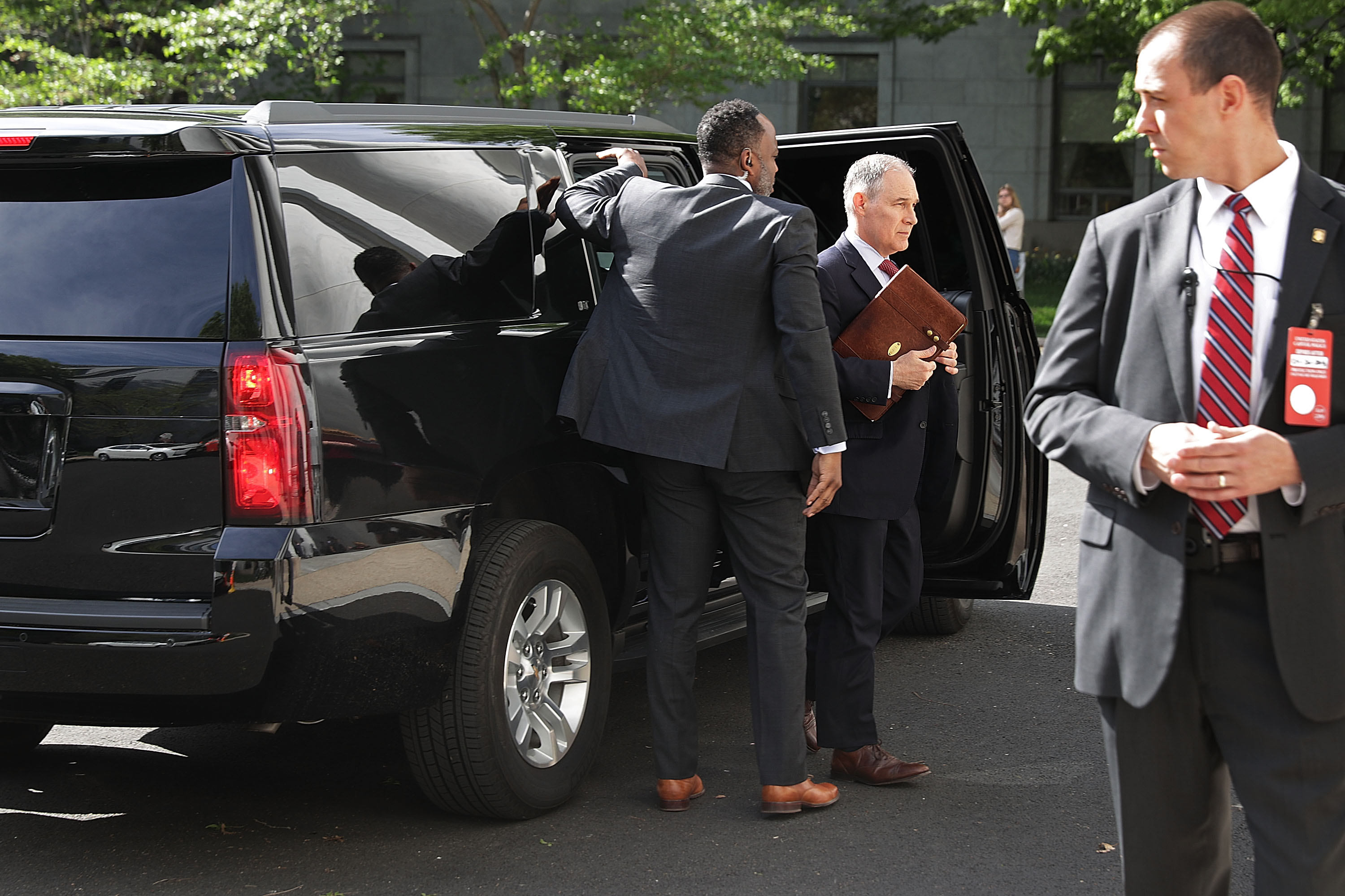 Surrounded by security agents, Environmental Protection Agency Administrator Scott Pruitt (2nd R) steps out of his armored SUV as he arrives to testify before the House Energy and Commerce Committee's Environment Subcommittee outside the Rayburn House Office Building on Capitol Hill April 26, 2018 in Washington, DC. (CREDIT: Chip Somodevilla/Getty Images)