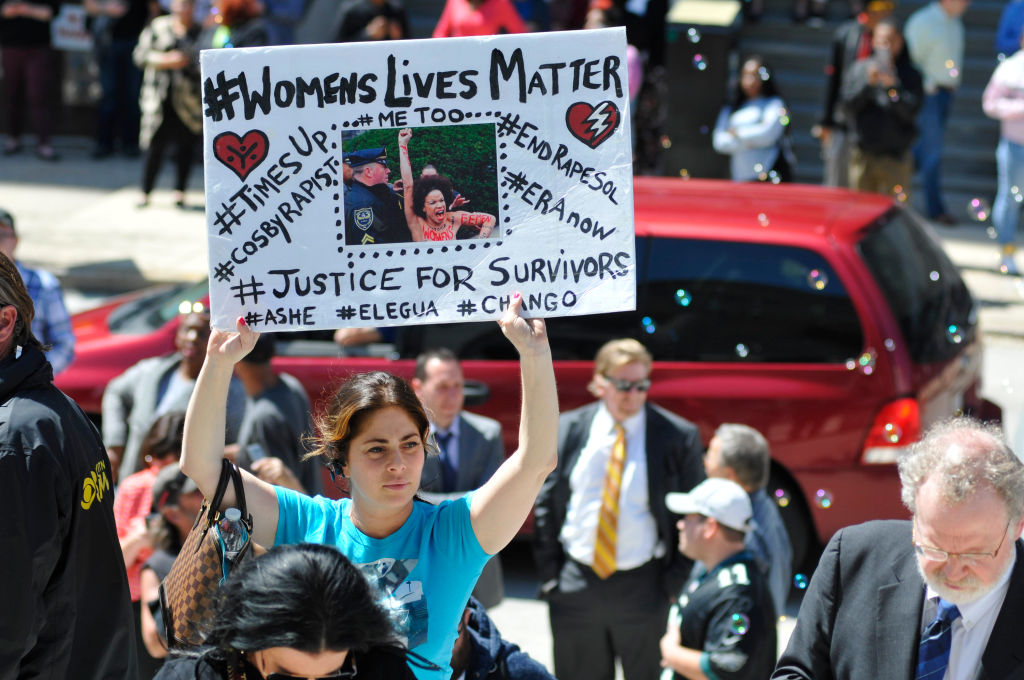 Activists protest as Bill Cosby departs after the second day of jury deliberations of the actor and comedian's sexual assault trial at the Montgomery County Courthouse in Norristown, PA, on April 26, 2018. CREDIT: Bastiaan Slabbers/NurPhoto via Getty Images