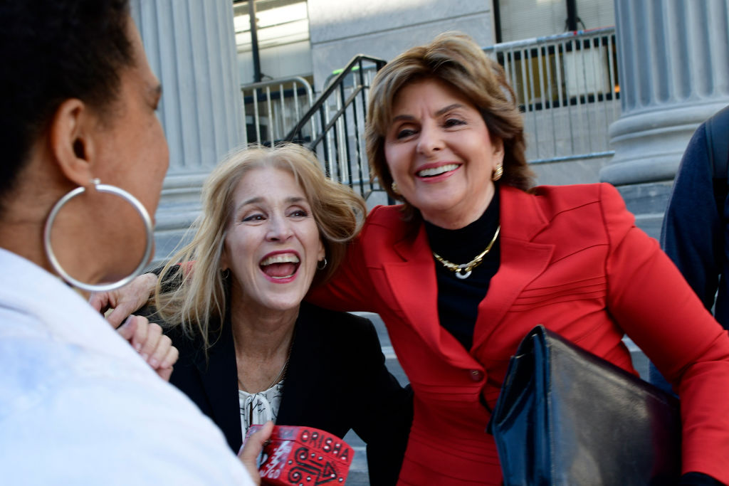 Lili Bernard hands out tokens to Therese Serignese and Gloria Allred as victims and supporters react after the guilty verdict of Bill Cosby in Norristown, PA, on April 26, 2018. CREDIT: Bastiaan Slabbers/NurPhoto via Getty Images