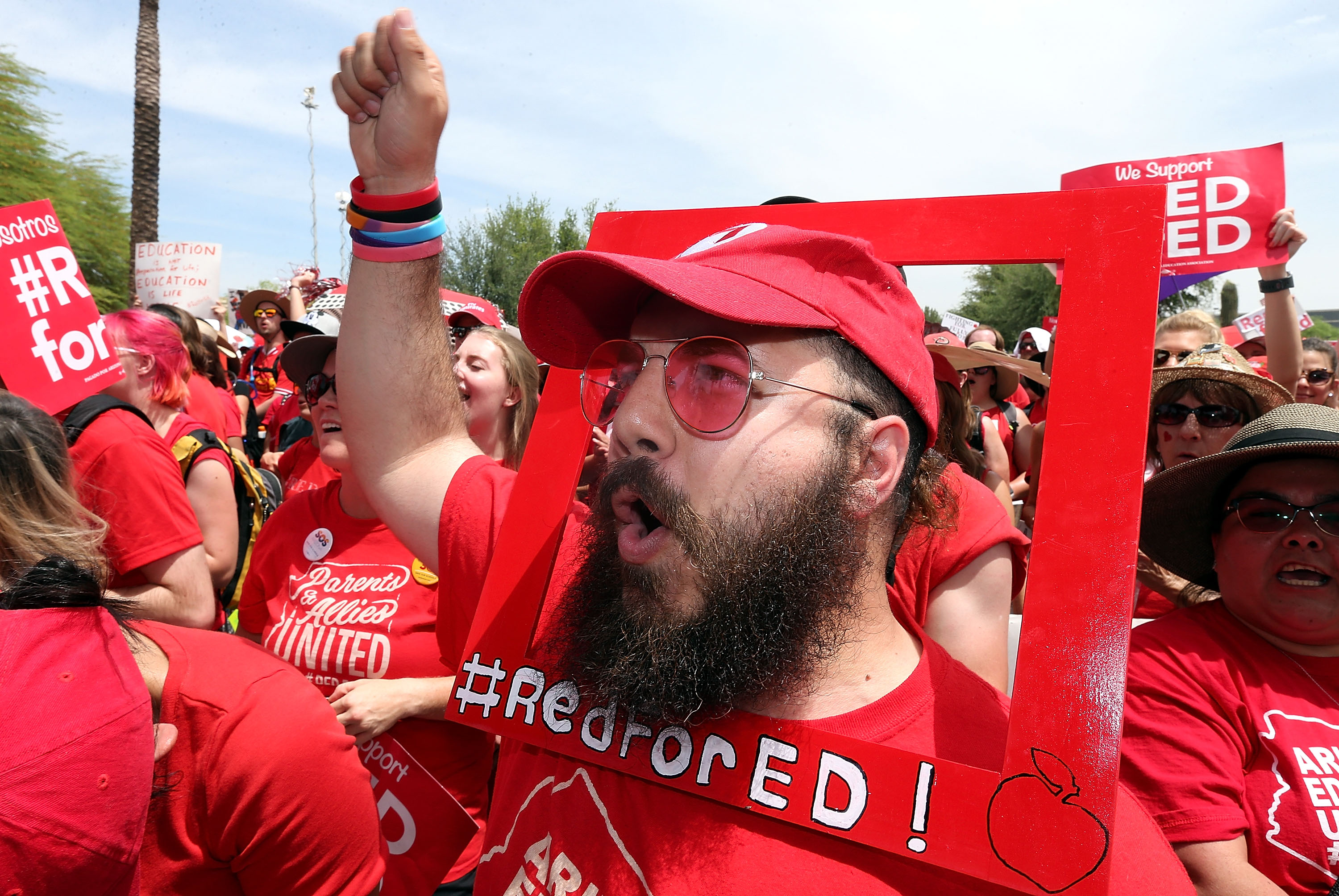Aude Odeh, an english teacher at Barry Goldwater High School, cheers in support of the #REDforED movement during a rally in front of the State Capitol on April 26, 2018 in Phoenix, Arizona. (Credit: Ralph Freso/Getty Images)