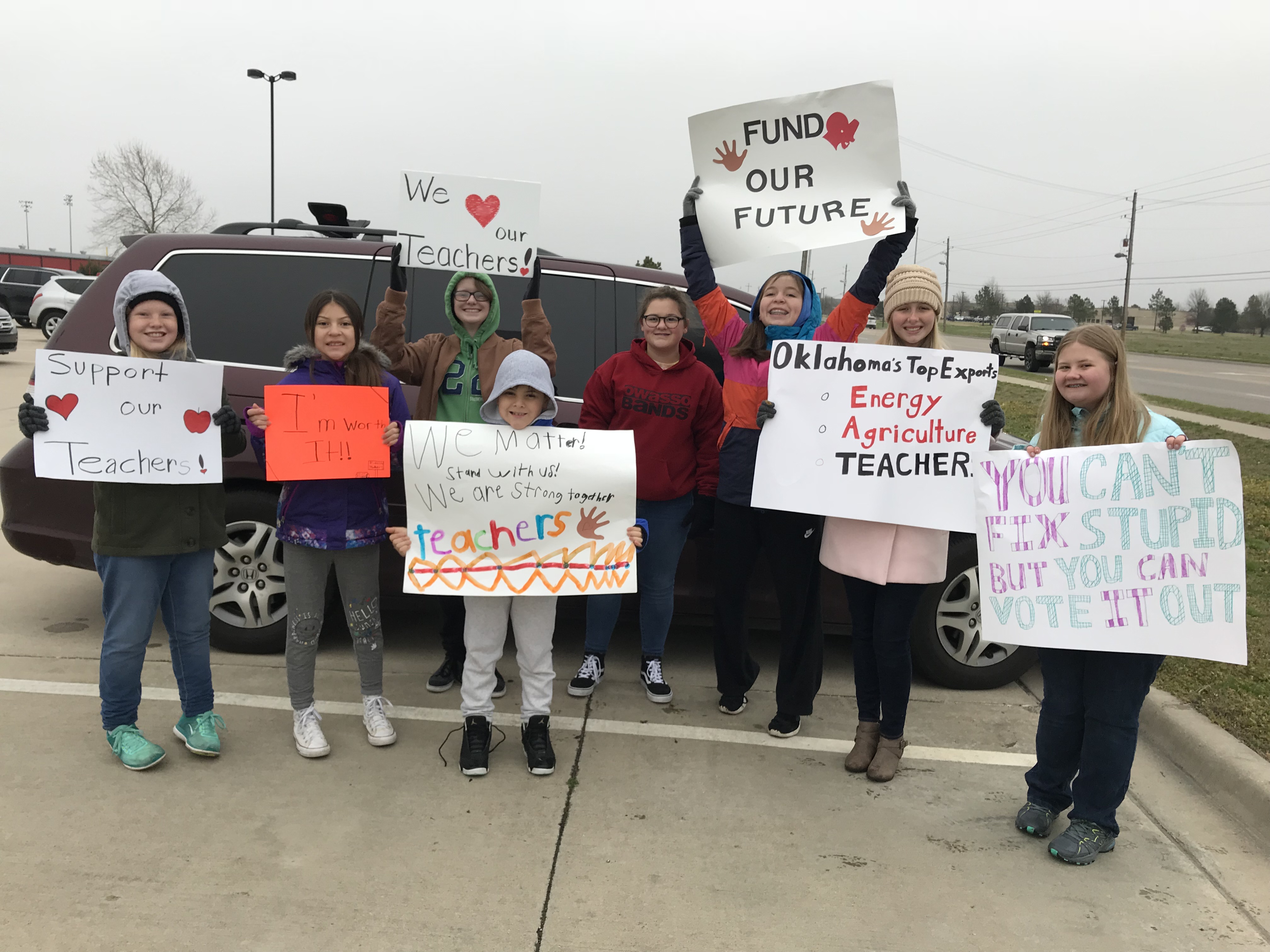 Children hold signs in support of the Oklahoma teacher walkout in Owasso, OK in April 2018. (Photo: Permission granted by Dana McConnell and children's parents)