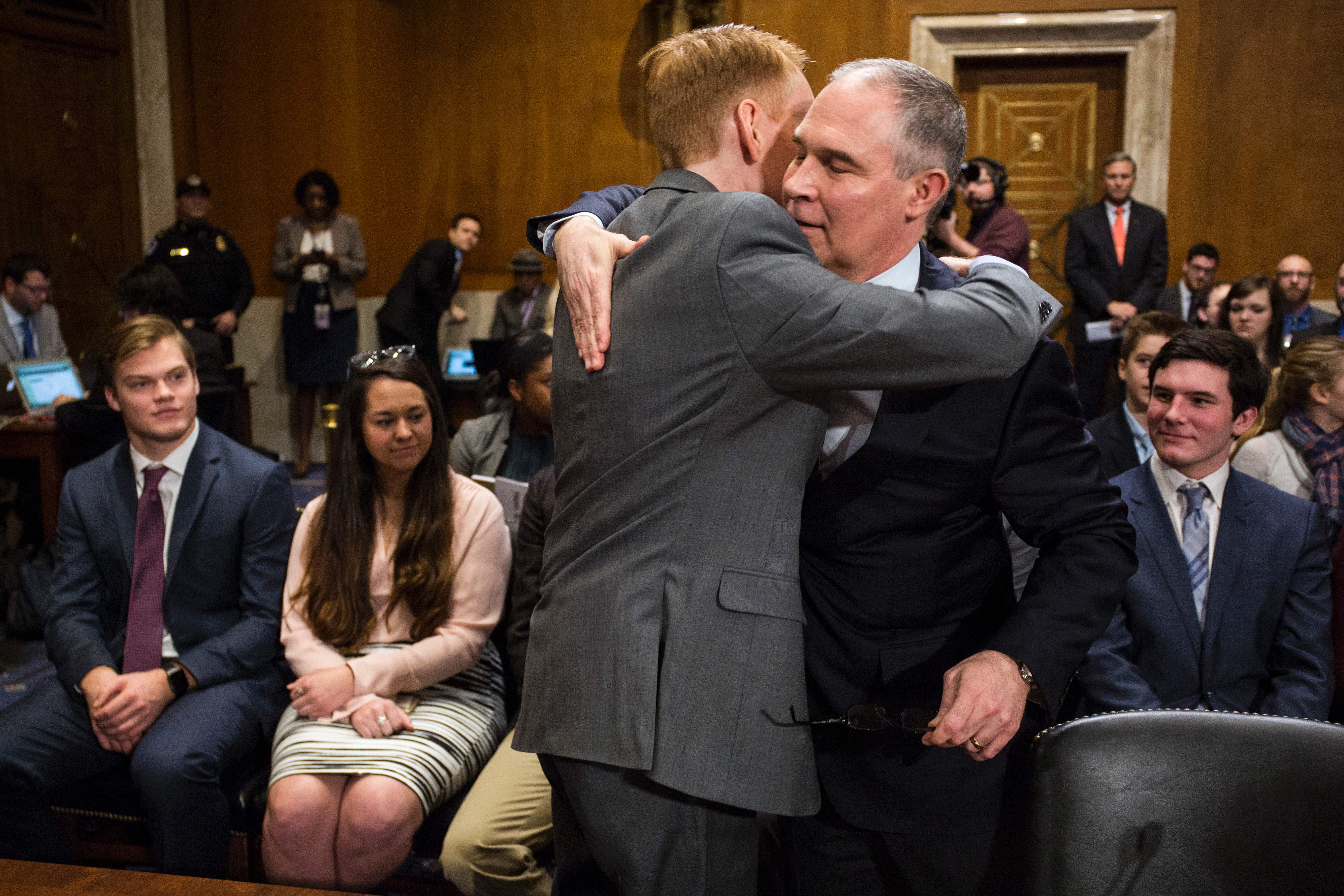 Sen. James Lankford (R-OK) embraces Scott Pruitt at the start of a Senate Environment and Public Works Committee confirmation hearing on January 18, 2017. CREDIT: ZACH GIBSON/AFP/Getty Images