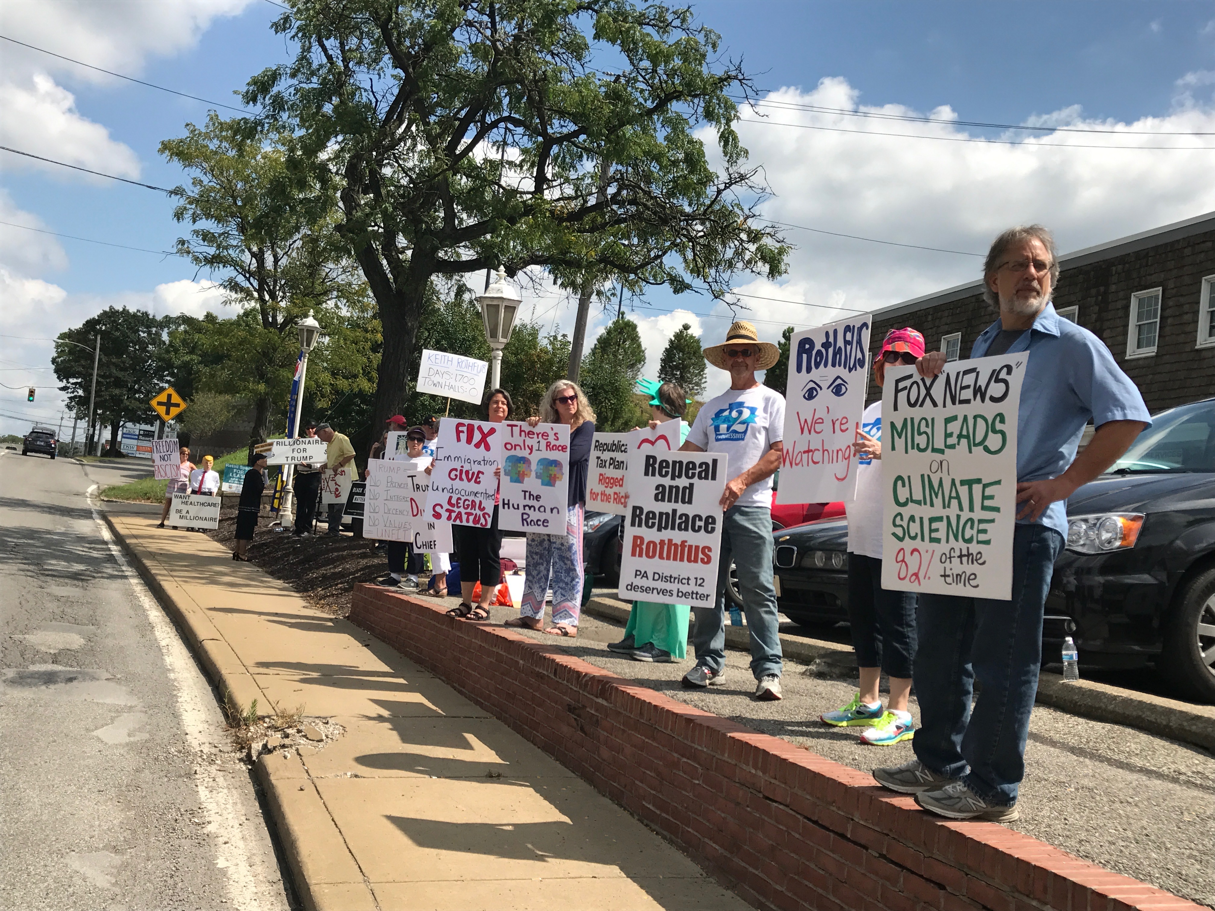 Protestors at the weekly "Where's Rothfus Wednesday" rally outside Rep. Rothfus's Ross Township office. (Credit: Courtesy of Alison Duncan)