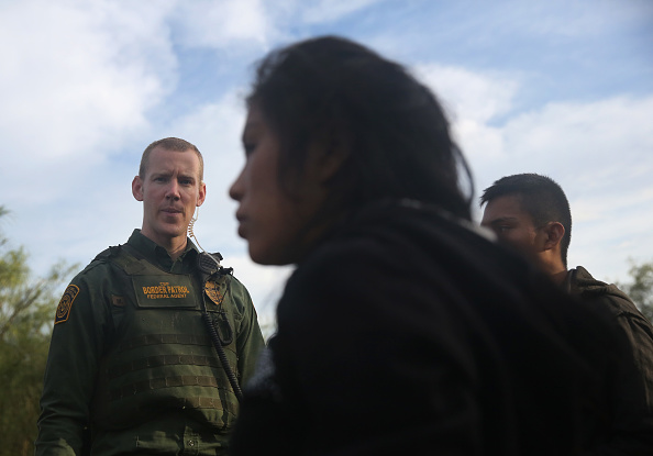 A U.S. Border Patrol agent watches over detained immigrants near the U.S.-Mexico border on August 16, 2016 in Roma, Texas. CREDIT: John Moore