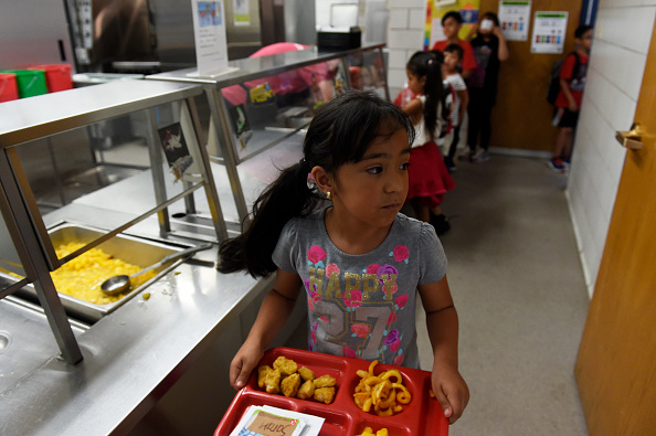 Sarah Carrasco, 7, takes her tray back to her seat during lunch at North Star Elementary School on June 5, 2017, in Thornton, Colorado. Adams 12 Five Star Schools offers free breakfast and/or lunch this summer at six schools to children ages one to 18 years old along with a day program at select sites. (Photo by Seth McConnell/The Denver Post via Getty Images)