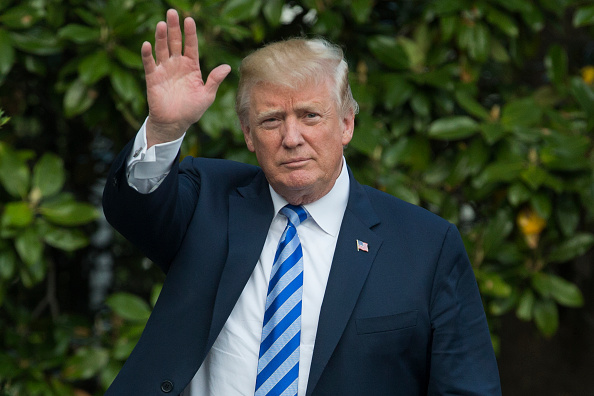 US President Donald Trump waves as he enters the White House after arriving on the South Lawn by Marine One, on May 4, 2018 in Washington, DC. (Photo by Michael Reynolds-Pool/Getty Images)