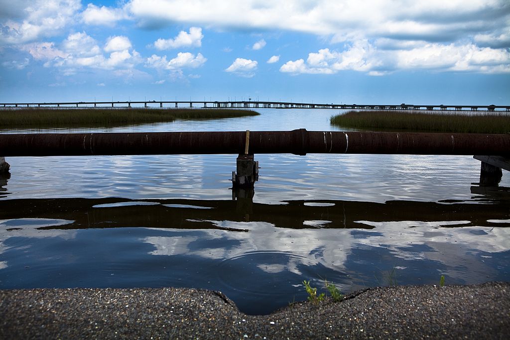 A rusted pipeline sits above the water in the area near the Deepwater Horizon disaster and the British Petroleum oil spill off the Gulf Coast on June 14, 2010 in Grand Isle, Louisiana, USA. CREDIT: Jeff Hutchens/Getty Images