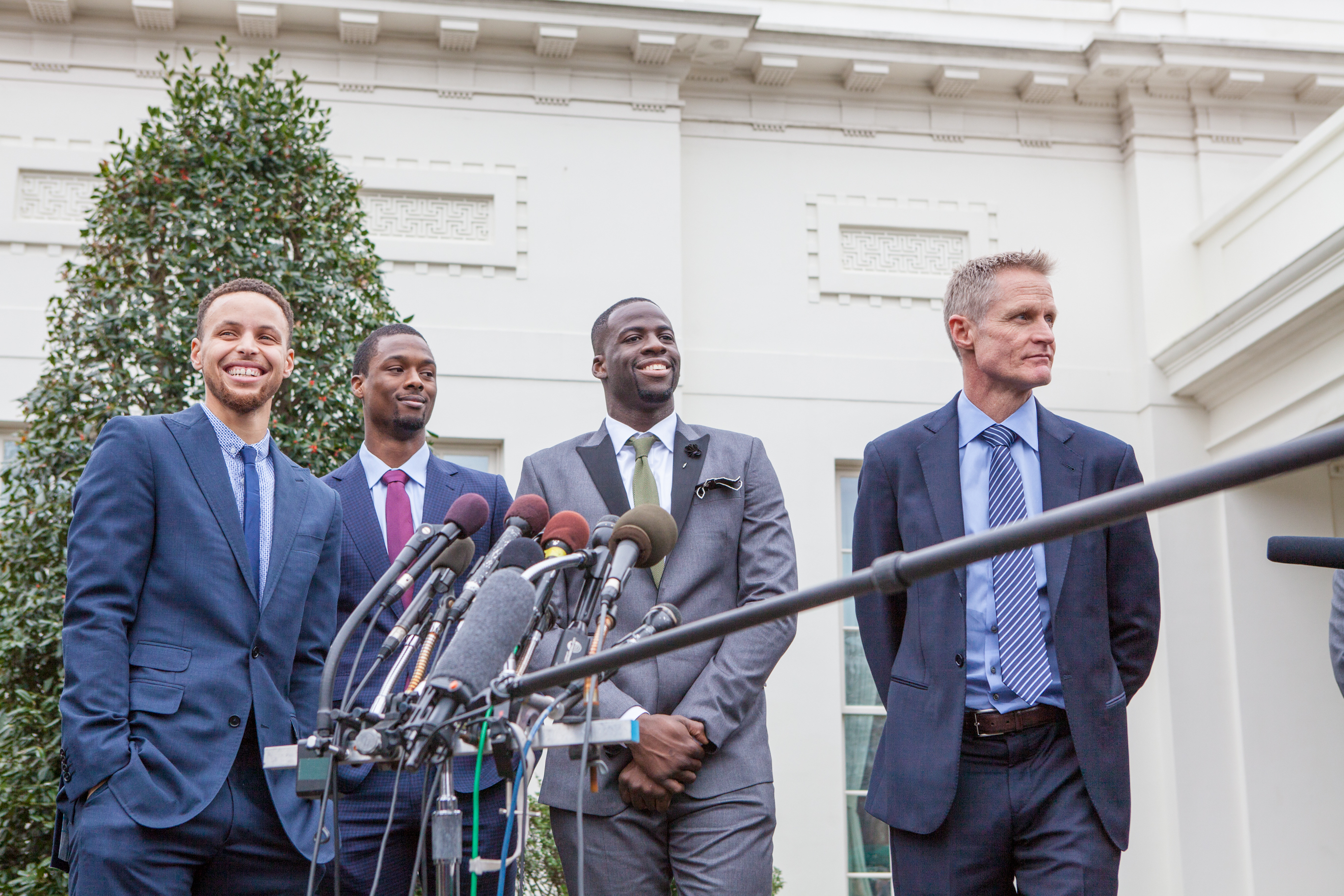 On Thursday, February 4, from left to right, Golden State Warriors point guard Stephen Curry, Forward Harrison Barnes, Forward Draymond Green and Head coach Steve Kerr, answer questions from reporters outside of the West Wing of the White House. CREDIT: Photo by Cheriss May/NurPhoto)
