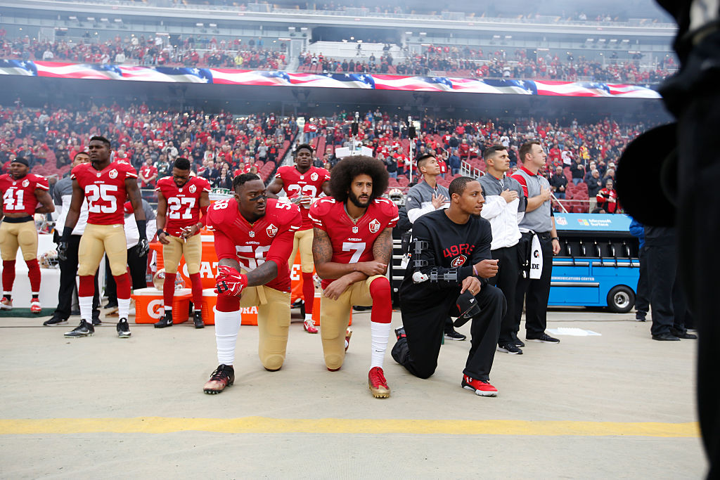 SANTA CLARA, CA - DECEMBER 11: Eli Harold #58, Colin Kaepernick #7 and Eric Reid #35 of the San Francisco 49ers kneel on the sideline, during the anthem, prior to the game against the New York Jets at Levi Stadium on December 11, 2016 in Santa Clara, California. CREDIT: Michael Zagaris/San Francisco 49ers/Getty Images