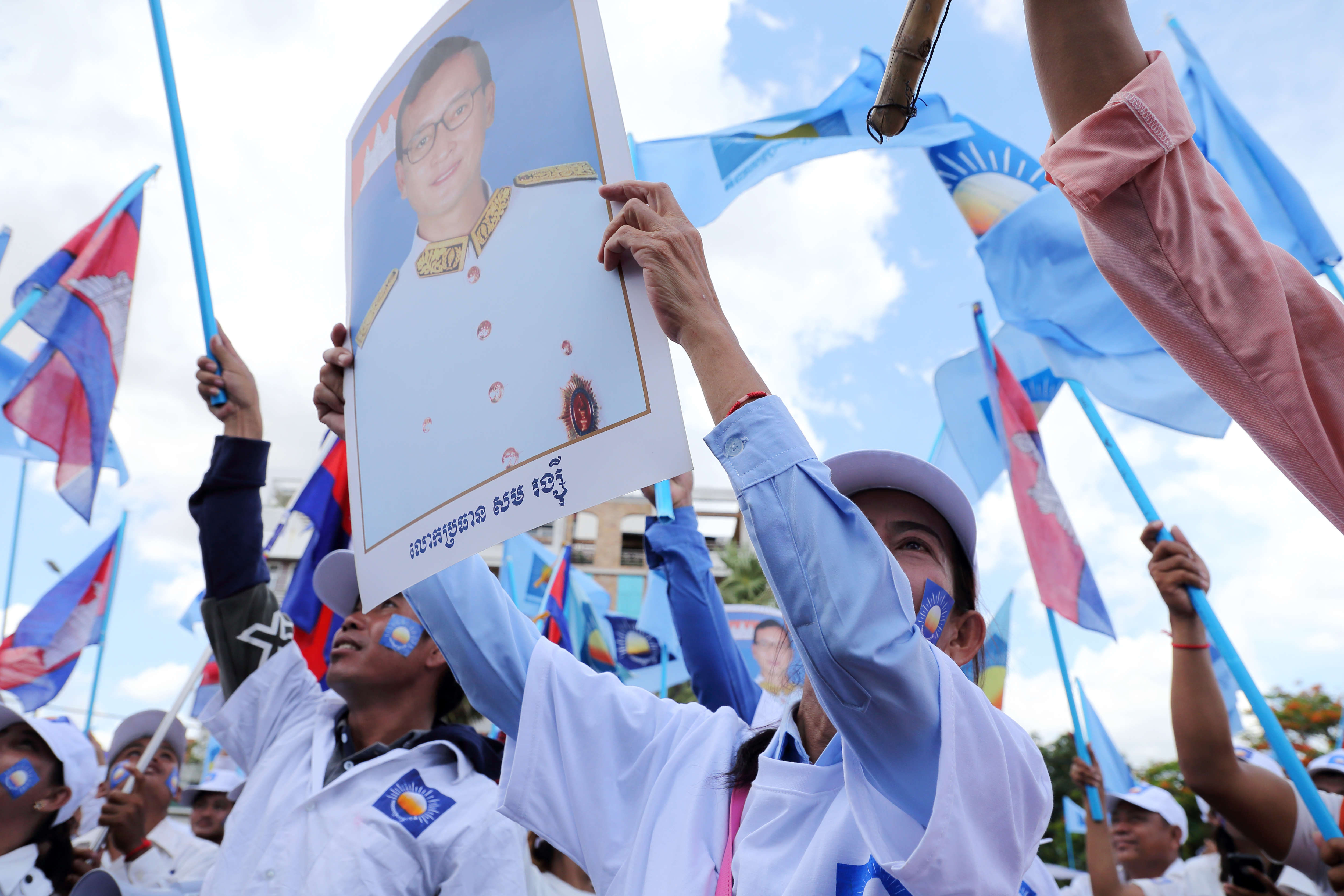 A supporter of the opposition Cambodia National Rescue Party holds up poster of former CNRP President Sam Rainsy during a rally on the last day of campaigning for the commune elections 2017. (Credit: Satoshi Takahashi/LightRocket via Getty Images)