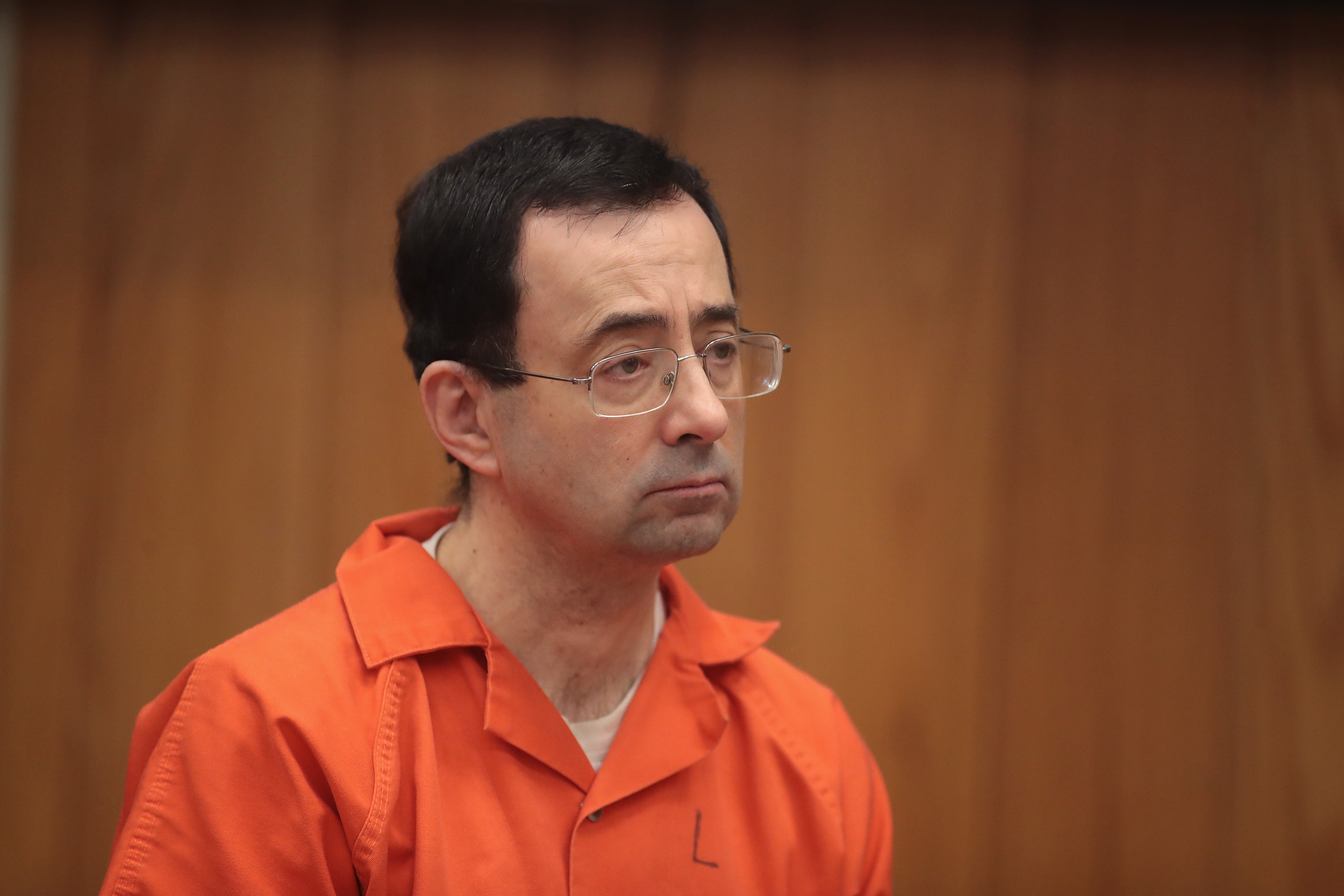 CHARLOTTE, MI - FEBRUARY 05: Larry Nassar stands as he is sentenced by Judge Janice Cunningham for three counts of criminal sexual assault in Eaton County Circuit Court on February 5, 2018 in Charlotte, Michigan. (Credit: Scott Olson/Getty Images)