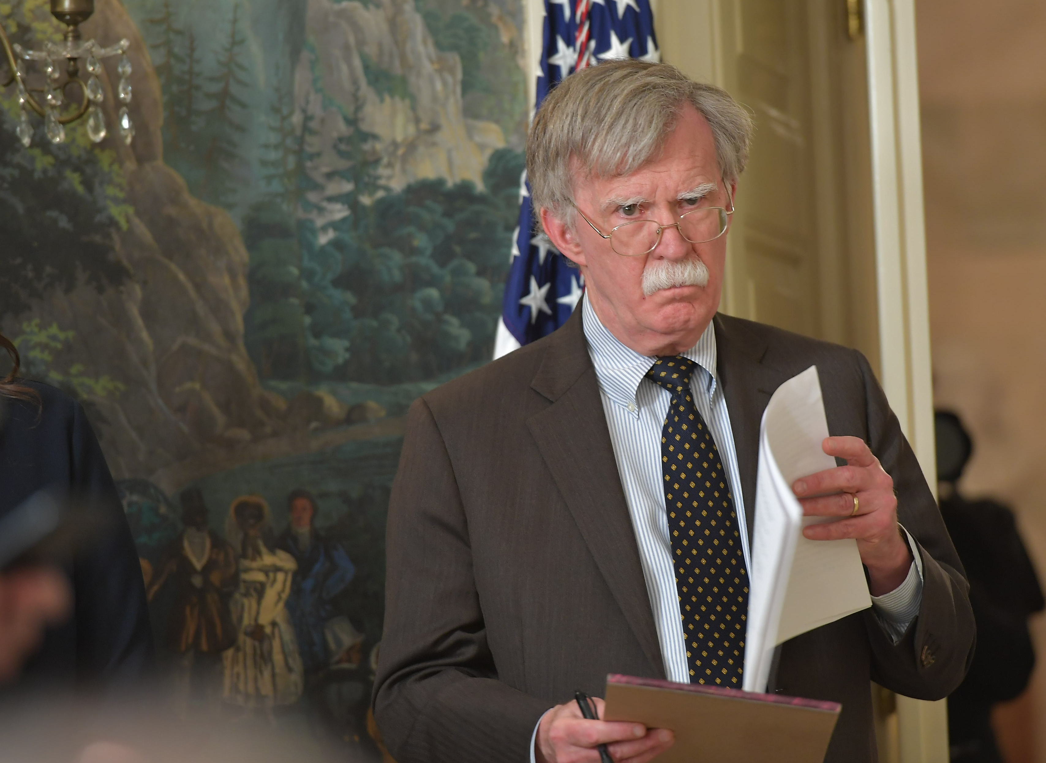National Security Adviser John Bolton listens as President Trump addresses the nation on the situation in Syria. CREDIT: MANDEL NGAN/AFP/Getty Images