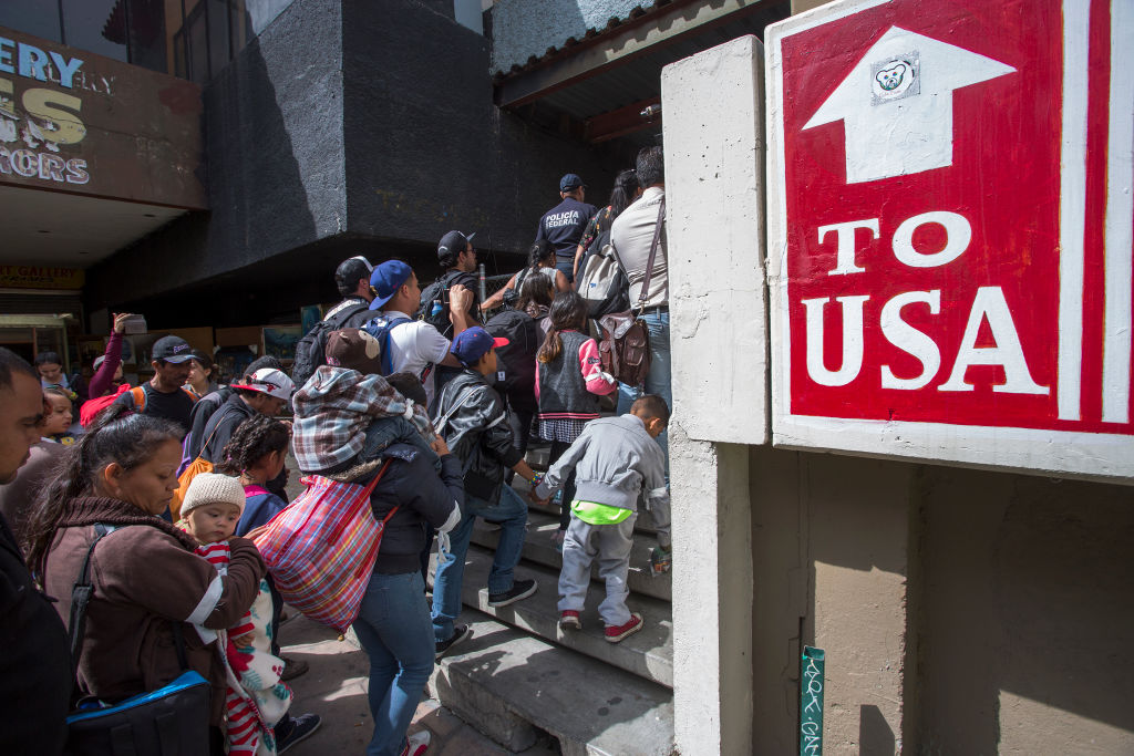 TIJUANA, MEXICO - APRIL 29: Members of a caravan of Central Americans who spent weeks traveling across Mexico walk from Mexico to the U.S. side of the border to ask authorities for asylum on April 29, 2018. (Photo by David McNew/Getty Images)