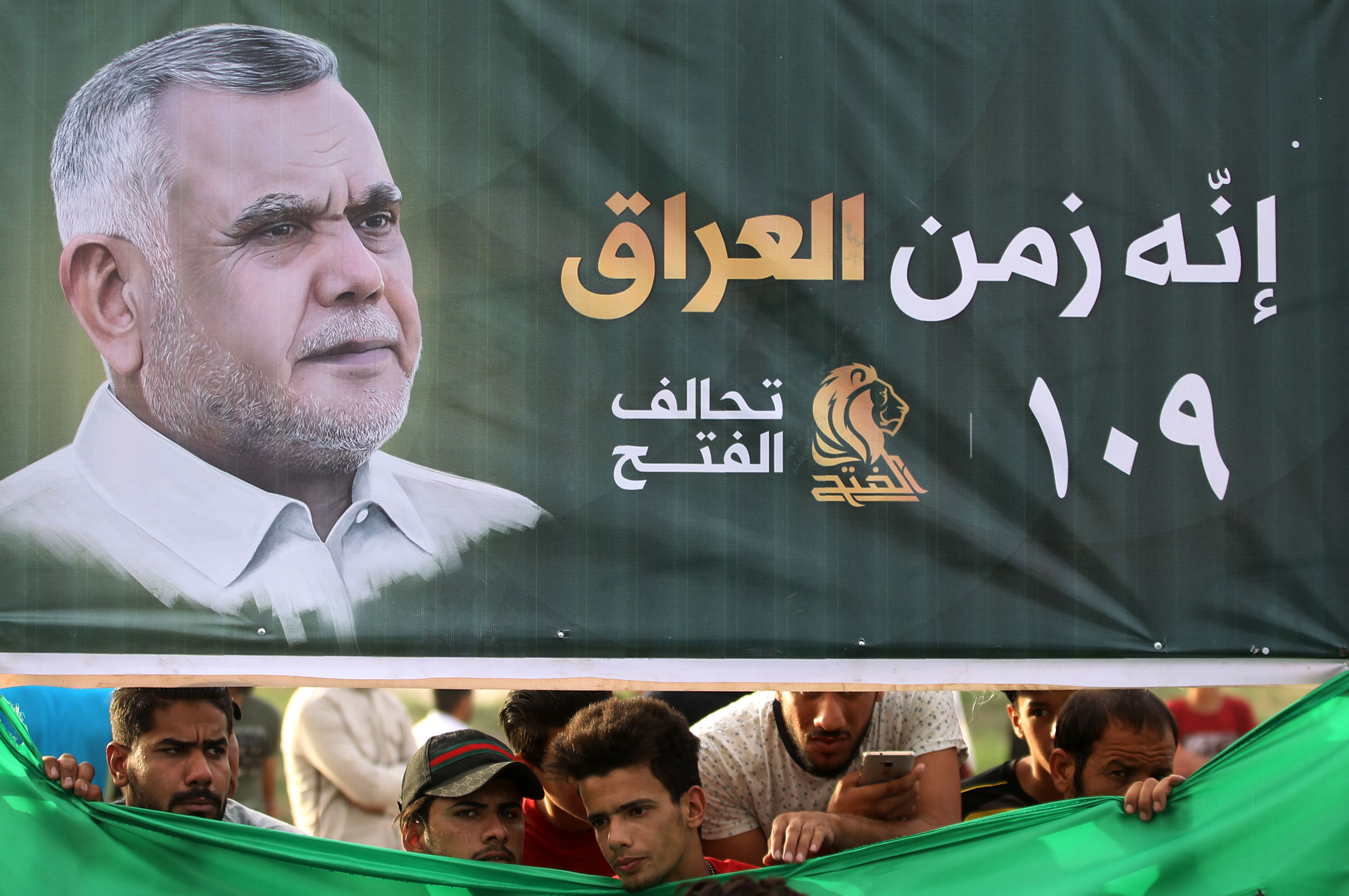 Iraqi supporters of the Fatah Alliance, a coalition of Iranian-supported militia groups, listen to a speech by Hadi al-Amiri, head of the Iranian-backed Badr Organization and leader of the Fateh Alliance, during a campaign rally in Baghdad on May 7, 2018. (CREDIT: Ahmad al-Rubaye/AFP/Getty Images)