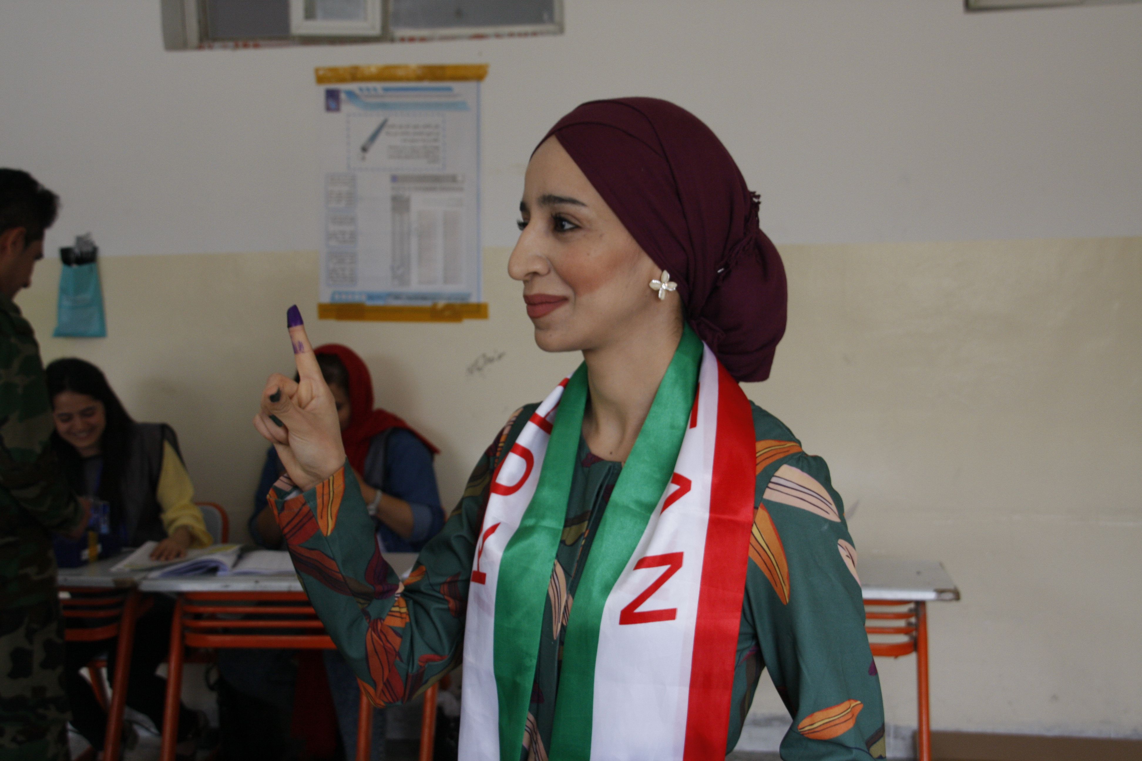 A member of the Iraqi Kurdish Peshmerga shows her ink-stained index finger after voting at a polling station ahead of parliamentary elections in the Iraqi Kurdish city of Sulaimaniyah on May 10, 2018. (CREDIT: Shwan Mohammed/AFP/Getty Images)
