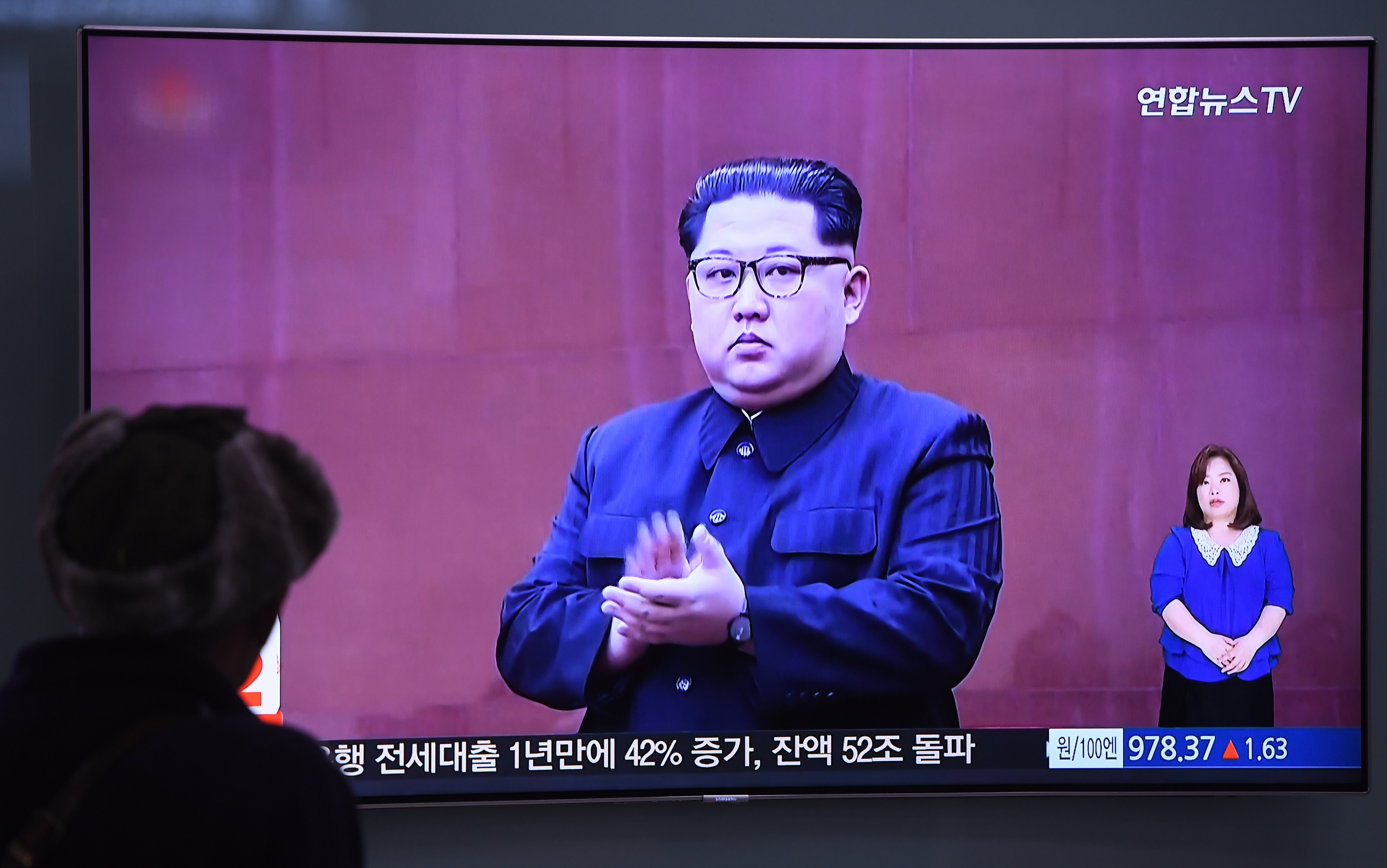 A man watches a television news screen showing North Korean leader Kim Jong Un at a railway station in Seoul on May 16, 2018. CREDIT: Jung Yeon-Je/AFP/Getty Images.