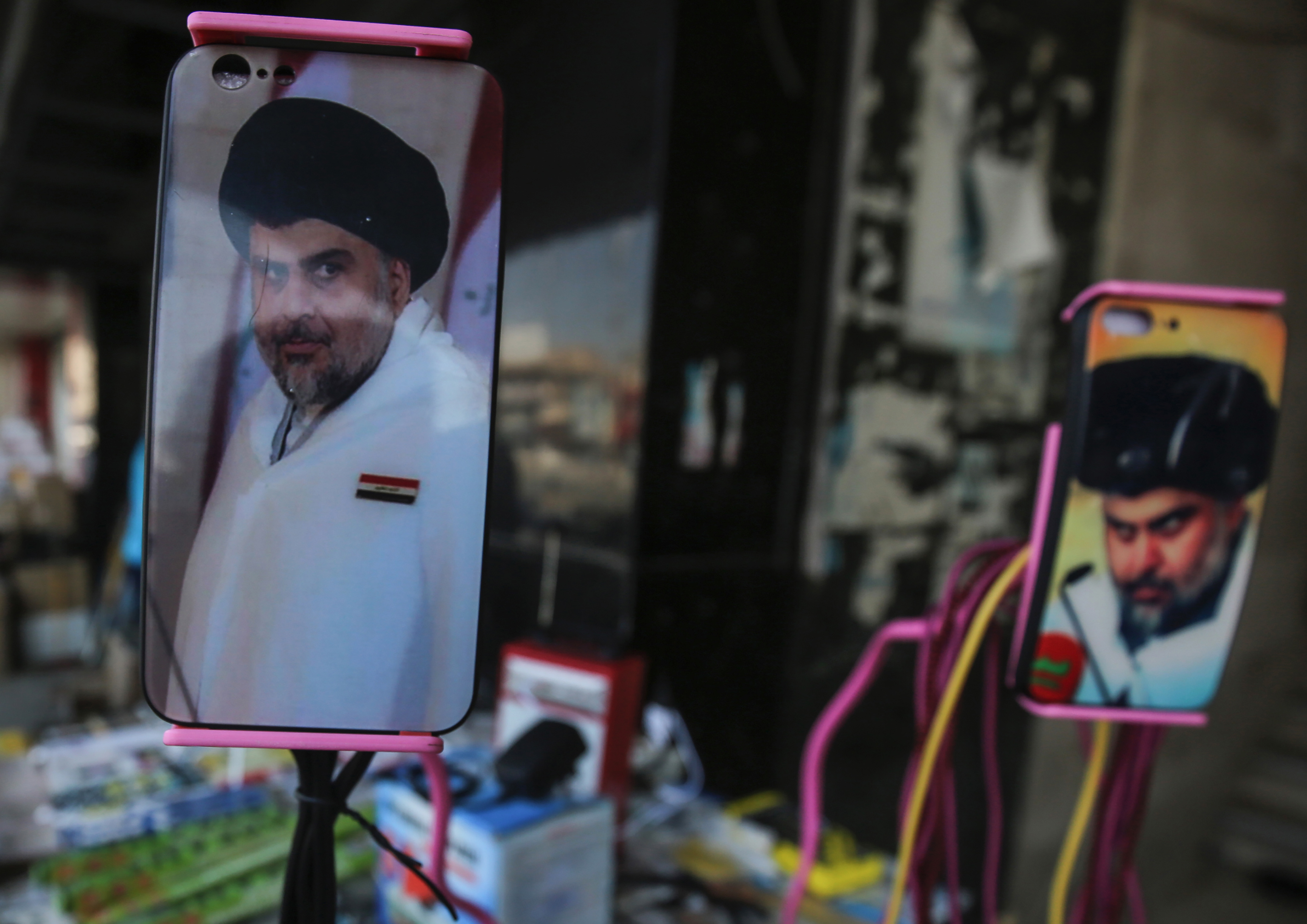 A picture taken on May 17, 2018 shows the face of Iraqi Shiite cleric and leader Muqtada al-Sadr adorning the plastic covers of cell phones, on display at a peddlar's stall in a market street in the capital Baghdad. (CREDIT: Ahmad al-Rubaye/AFP/Getty Images)