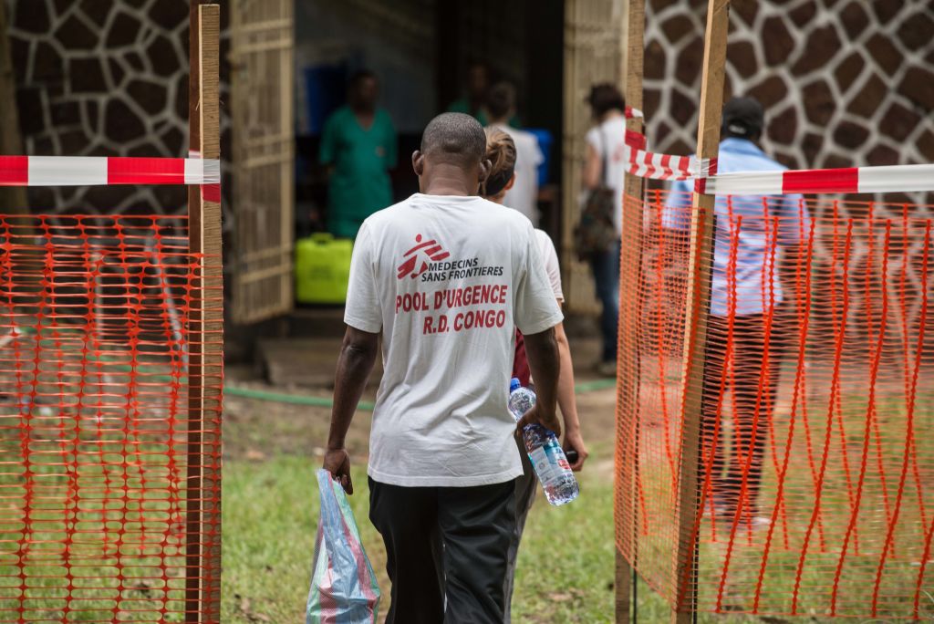 Medecins sans frontiere team members walk through an Ebola security zone at the entrance of the Wangata Reference Hospital in Mbandaka, northwest of DR Congo on May 20, 2018. Officials have reported at least 27 suspected deaths tied to the recent deadly Ebola outbreak in the region. (CREDIT: JUNIOR D. KANNAH/AFP/Getty Images)