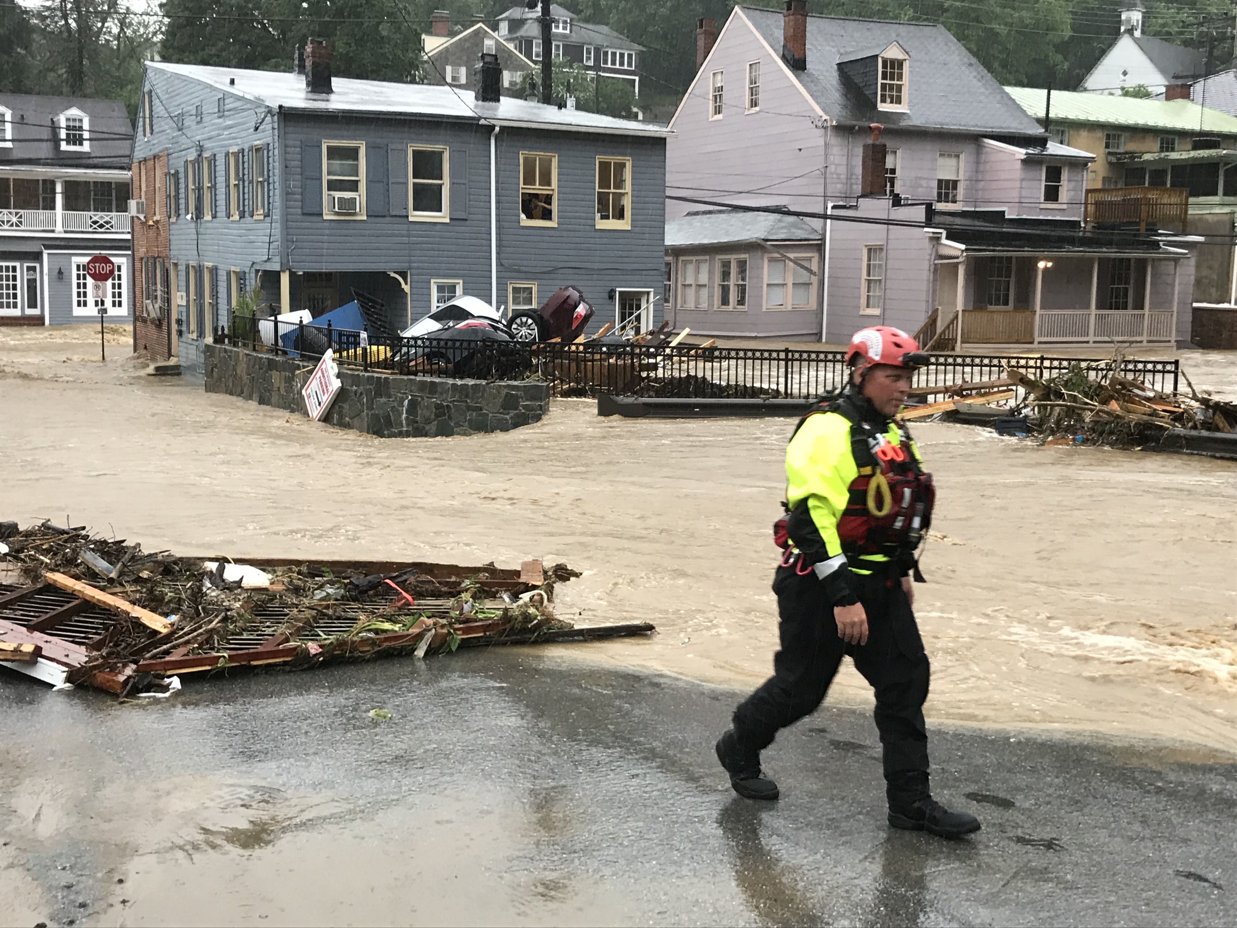 Vehicles washed into a pile behind a building in historic Ellicott City as flood waters raged through its streets following torrential thunderstorms in Elliott City, Maryland on May 27, 2018. (CREDIT: Katherine Frey/The Washington Post via Getty Images)
