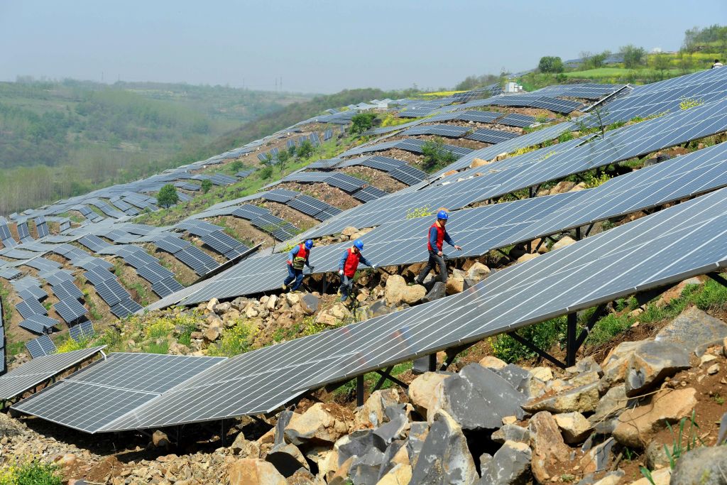 Chinese workers check solar panels in Anhui province, April 13, 2017.
CREDIT: STR/AFP/Getty Images
