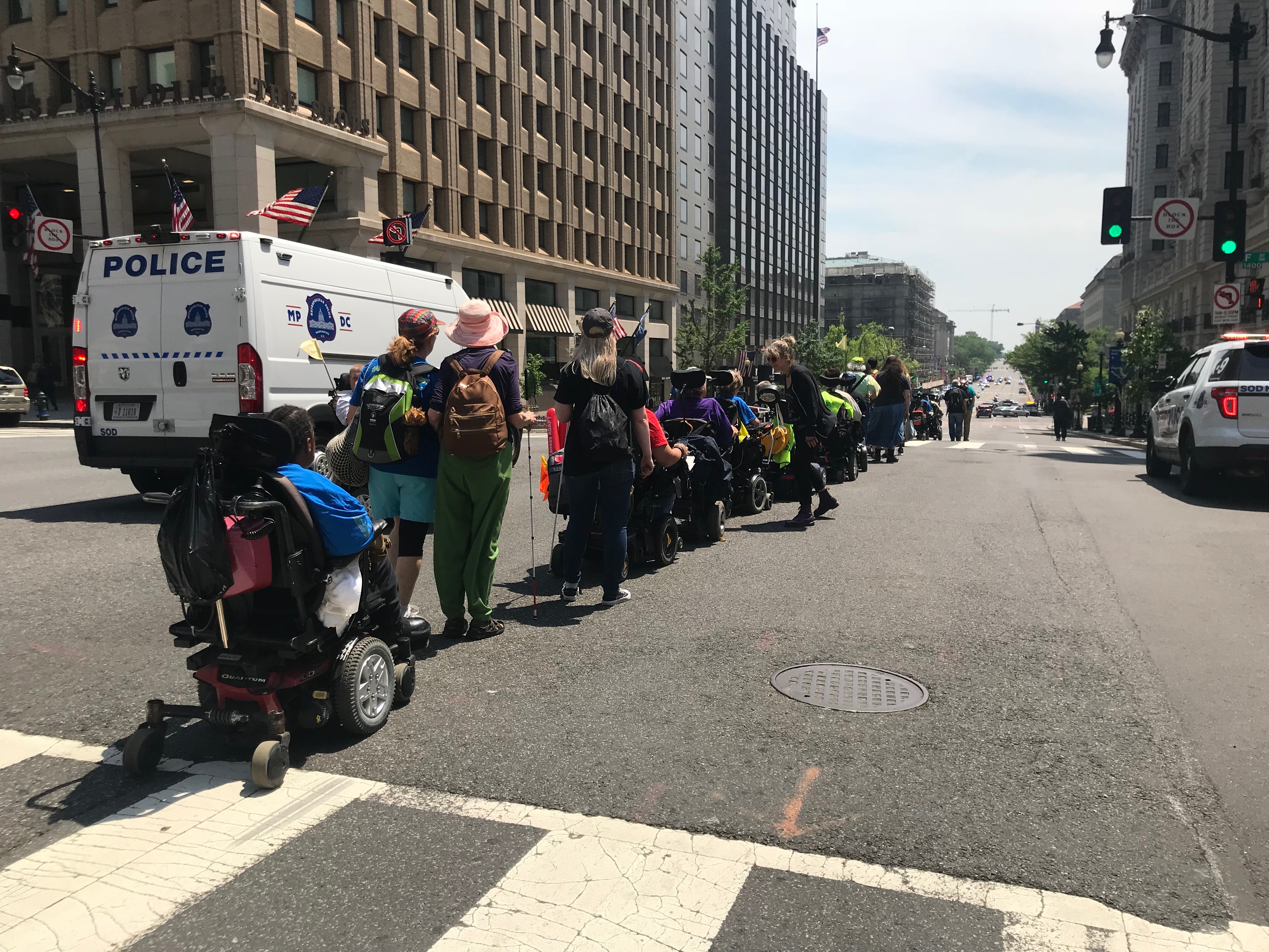 ADAPT activists line down 14th Street in Washington, D.C., May 15, 2018. (CREDIT: Amanda Michelle Gomez)